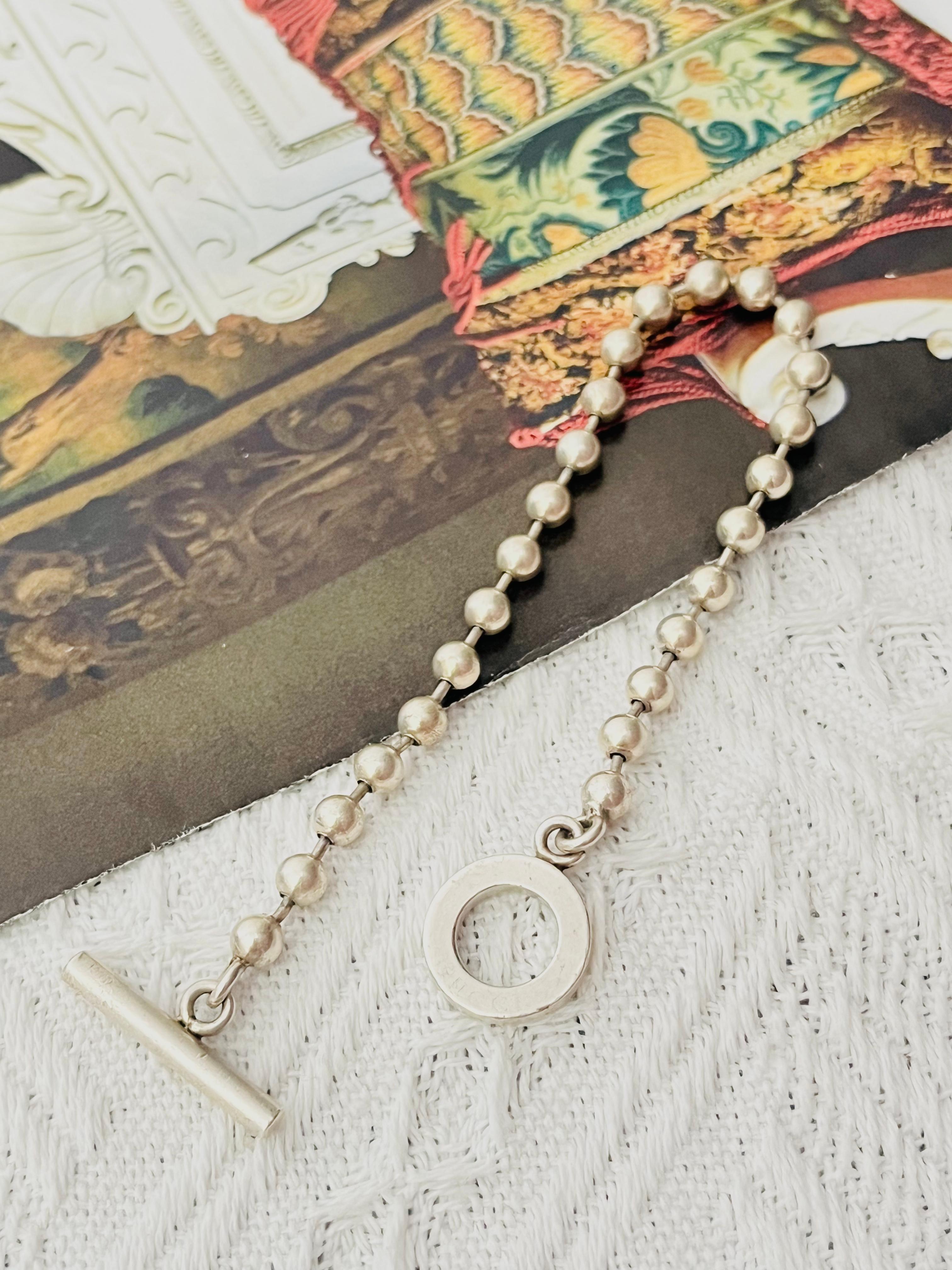 Gucci Vintage Unisex Logo Boule Circle Round Ball Dots Chain Pendant Charm Modernist Bracelet, Sterling Silver

Very good condition. Light scratches or colour loss, Signed at charm, but not very clear any longer. 100% Genuine.

Material: 925