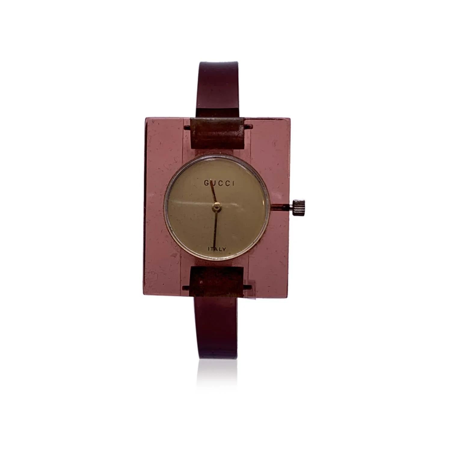 Please read carefully the COLOR description! Beautiful vintage bangle wristwatch by GUCCI in translucent lucite. The exact color turns towards brown with a slight reference to pink. Rectangle-shaped case.17 Jewels Swiss Wind-Up. Light gold dial.