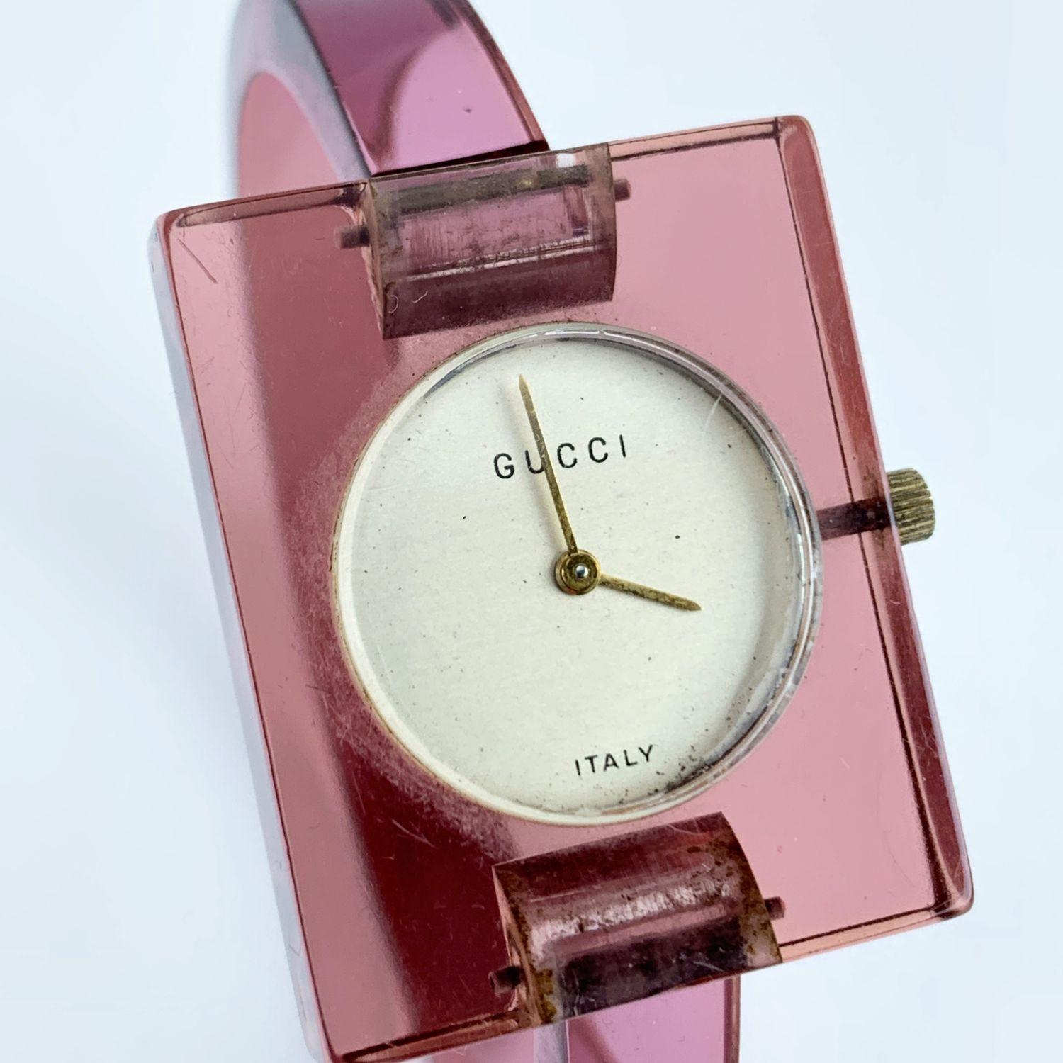 Beautiful vintage bangle wristwatch by GUCCI in translucent pink lucite. Rectangle-shaped case.17 Jewels Swiss Wind-Up. Light gold dial. Clasp closure. 'GUCCI' and 'Italy' embossed on the dial. Bracelet diameter: 2.25 Inches - 5,8 cm. Case width: 30
