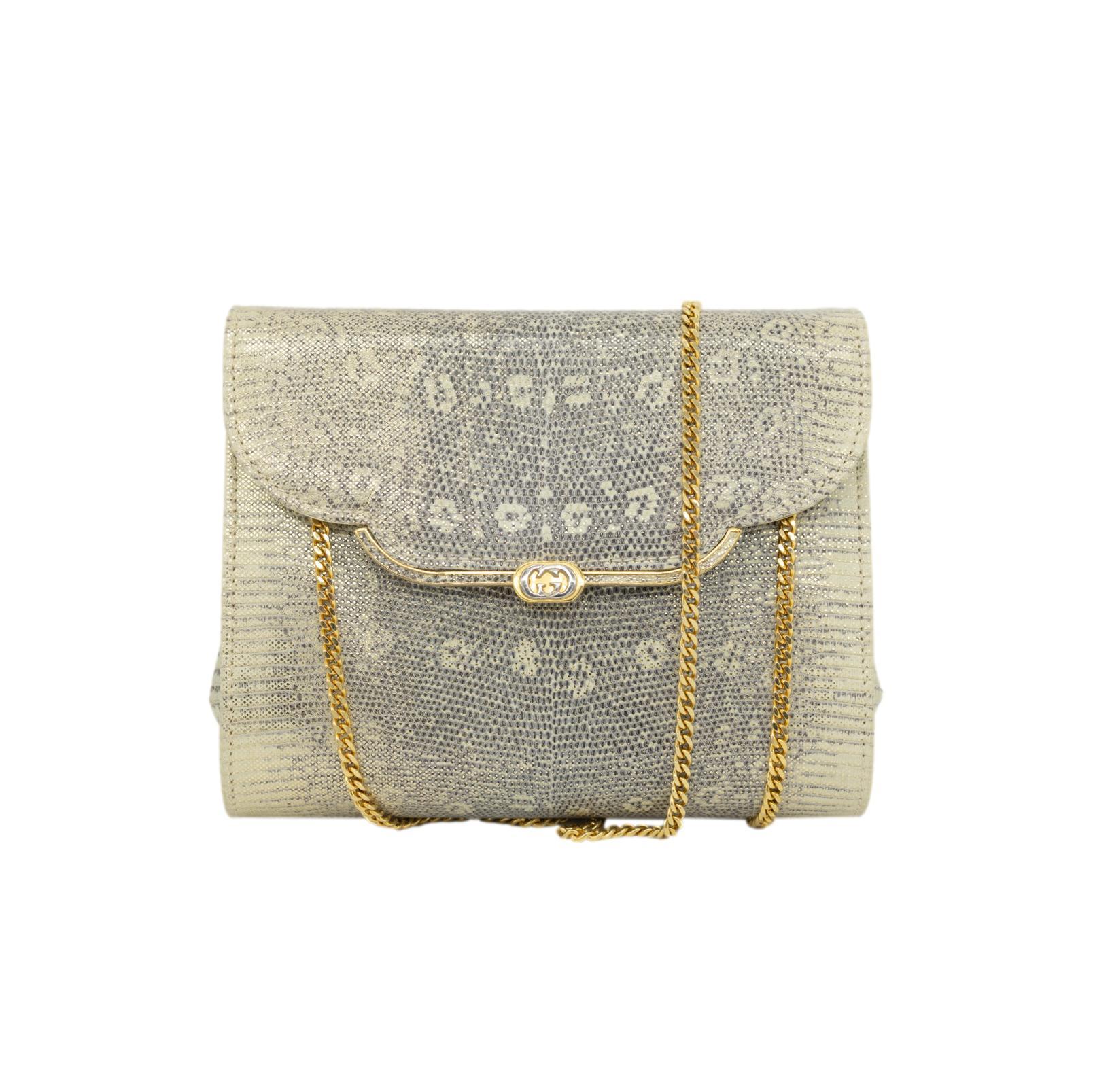 Gucci Vintage Metallic Monitor Lizard Leather Shoulder Clutch Evening Bag, 1970. This extremely rare and highly sought after vintage lizard bag is handcrafted from exotic and rare monitor lizard with an embossed metallic gold finish and lined with a