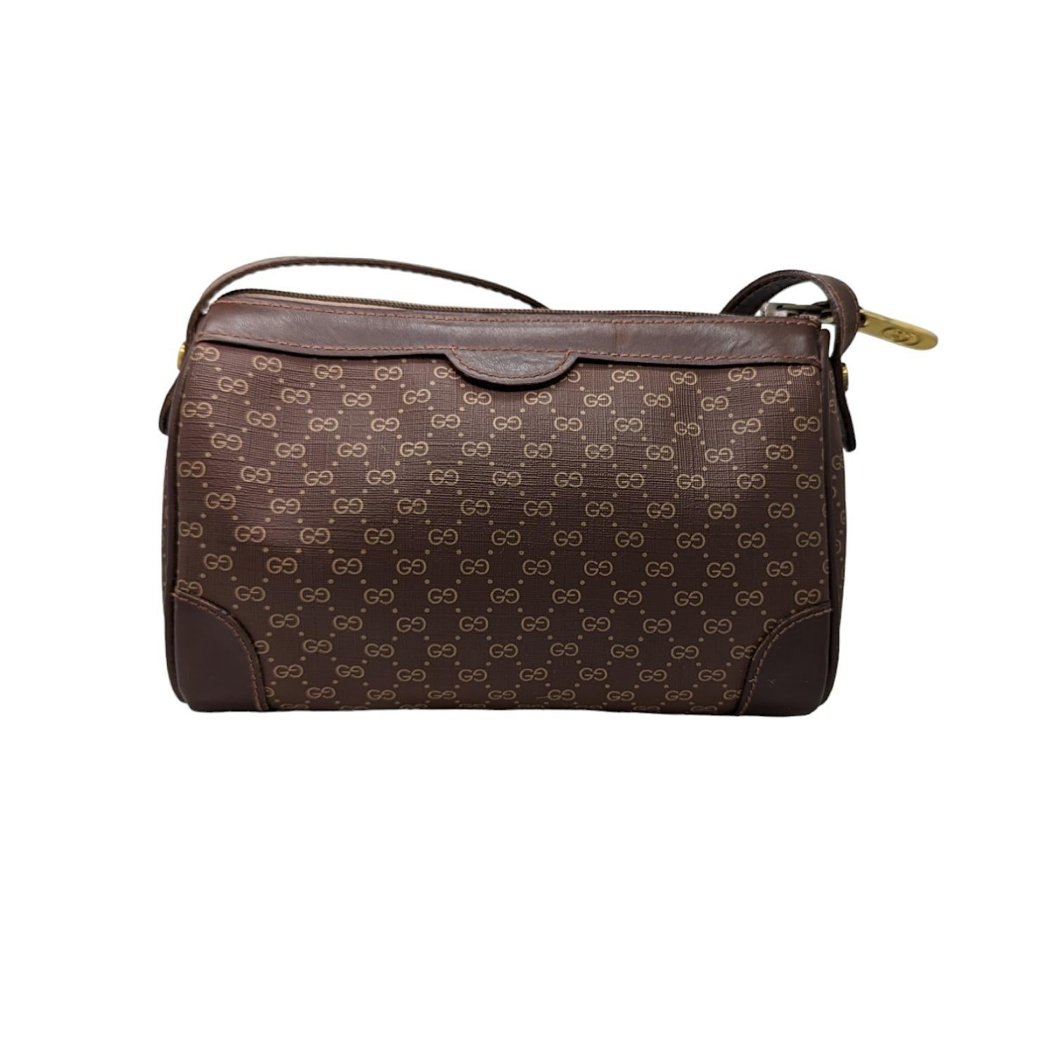 Own a piece of Gucci history with this stylish vintage camera bag! This beautiful Gucci crossbody is crafted from brown GG Micro Monogram canvas and features rich brown leather trim. Made in Italy, this piece dates to the 1970s and is a true