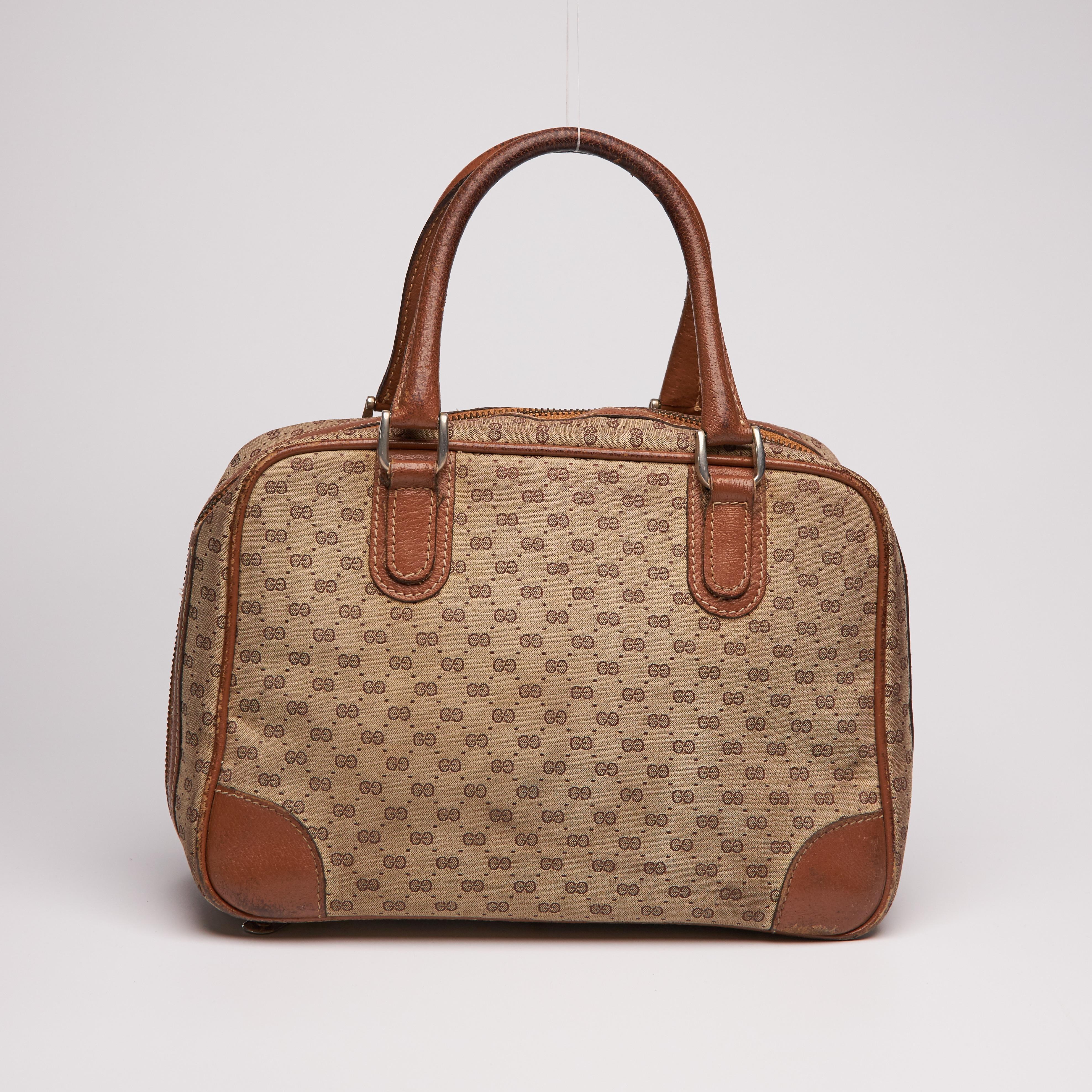 
This Gucci bag features micro GG Monogram coated canvas, gold tone hardware, dual rolled leather top handles, leather trim embellishment, top zip closure, leather lining and protective feet at base.

COLOR: Brown
MATERIAL: Coated canvas
ITEM CODE: