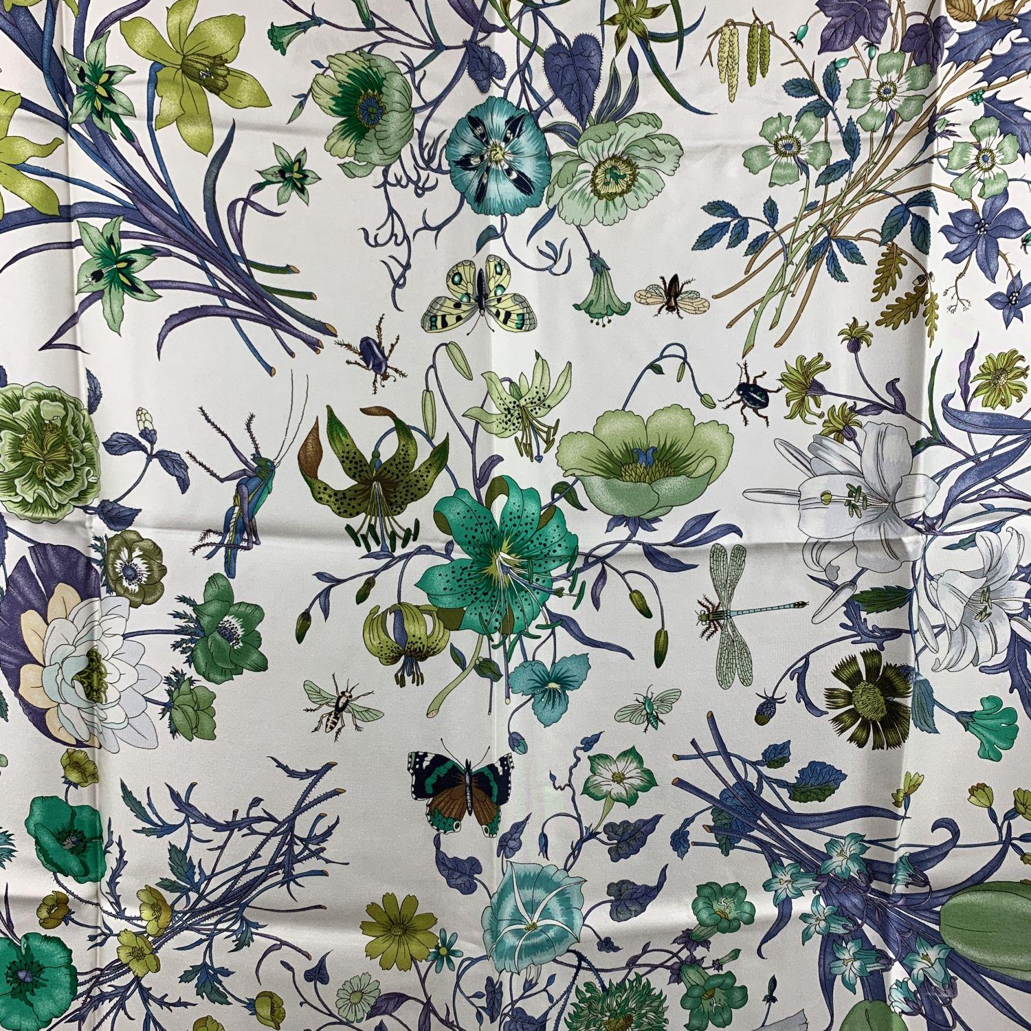 The Flora silk scarf born in 1966 by the artist Vittorio Accornero. He was the textile designer for Gucci between the 1960s and 1981. The Flora design is a magical and delicate composition of flowers, berries and insects depicted with the precision