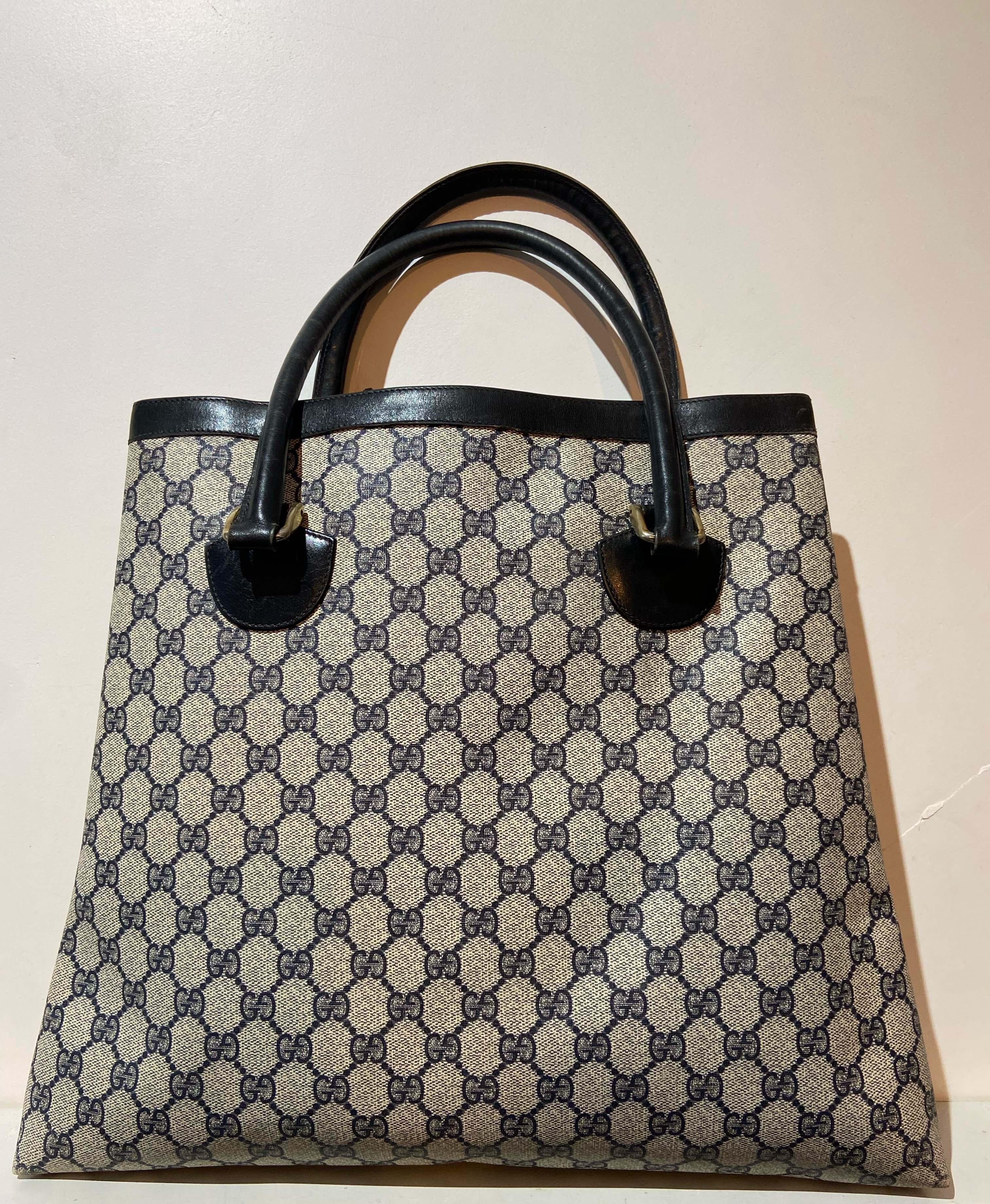 Vintage classic navy and grey GG canvas tote bag by Gucci. Feature a square shape and all over GG logo,PVC coated fabric and navy leather outline. Large inner back pocket. 

Brand: Gucci

Color: Navy/Grey
Year / Season: Circa late 1980's
Tote