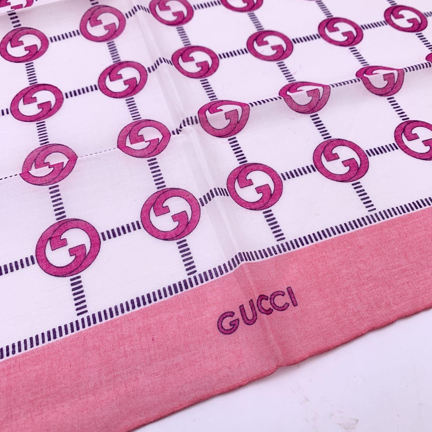 Vintage neck scarf by GUCCI. 100% Cotton. Pink GG logo pattern with pink borders. 'Gucci' signature printed on the lower center border. Approx. Measurements: 16.5 x 16.5 inches - 42 x 42 cm Details MATERIAL: Cotton COLOR: Pink MODEL: n.a. GENDER: