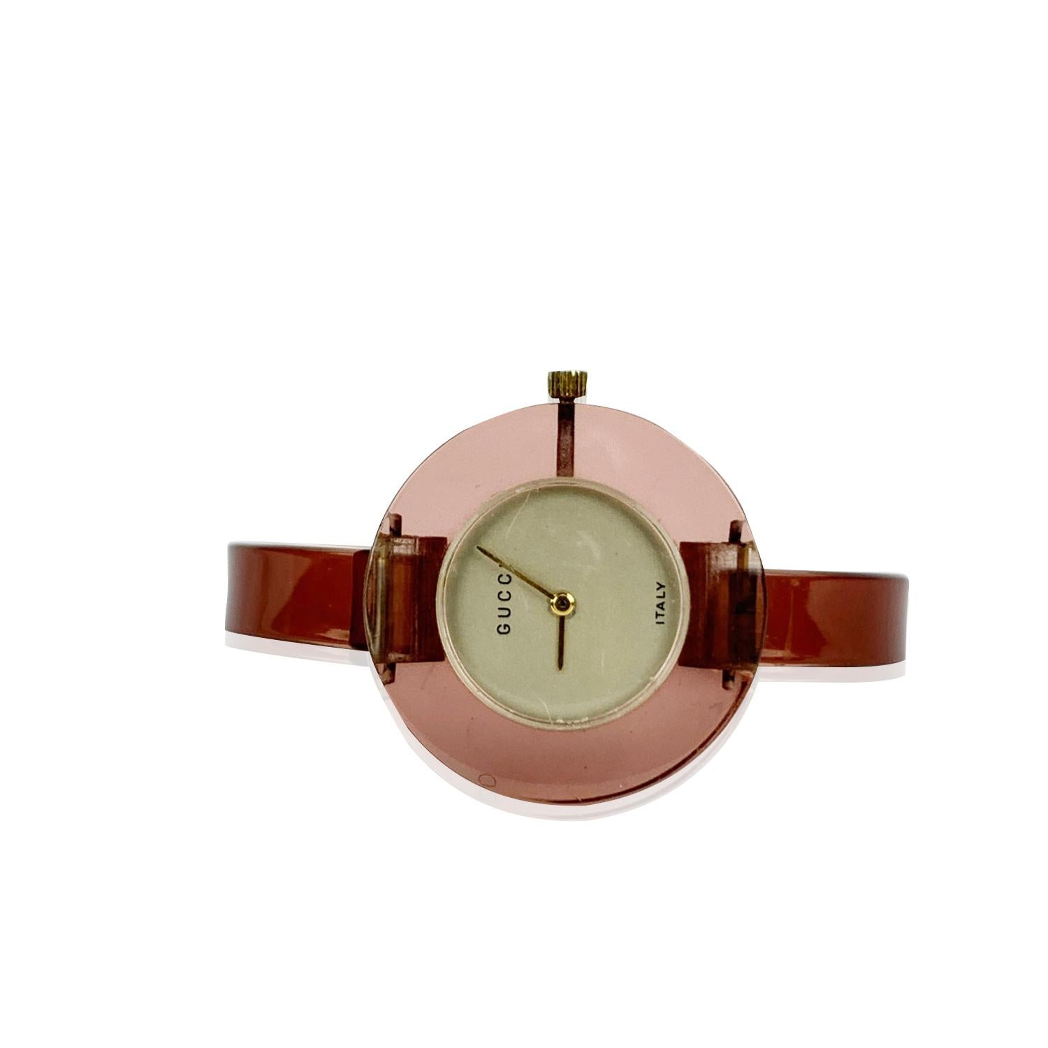 Beautiful vintage bangle wristwatch by GUCCI in translucent pink lucite. 17 Jewels Swiss Wind-Up. Light gold dial. Clasp closure. 'GUCCI' and 'Italy' embossed on the dial. Bracelet diameter: 2.25 Inches - 5,8 cm. Case diameter: 35 mm (38 mm