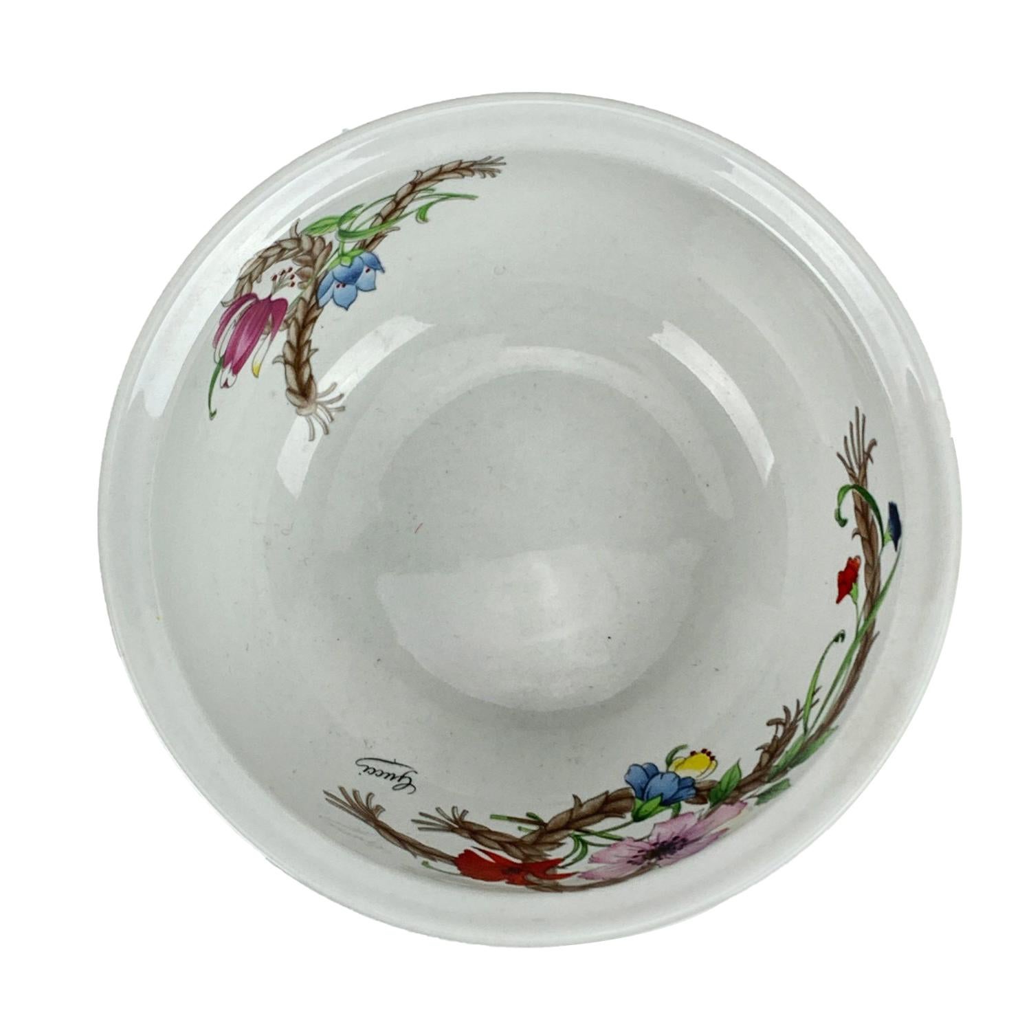 Gucci Vintage small bowl, from the 'Cesti e Nastri' line. Designed by Mancioli - Made in Italy. White porcelain with multicolored flowers and butterflies design. Flame resistant and microwave and dishwasher safe. Gucci signature on top and Gucci