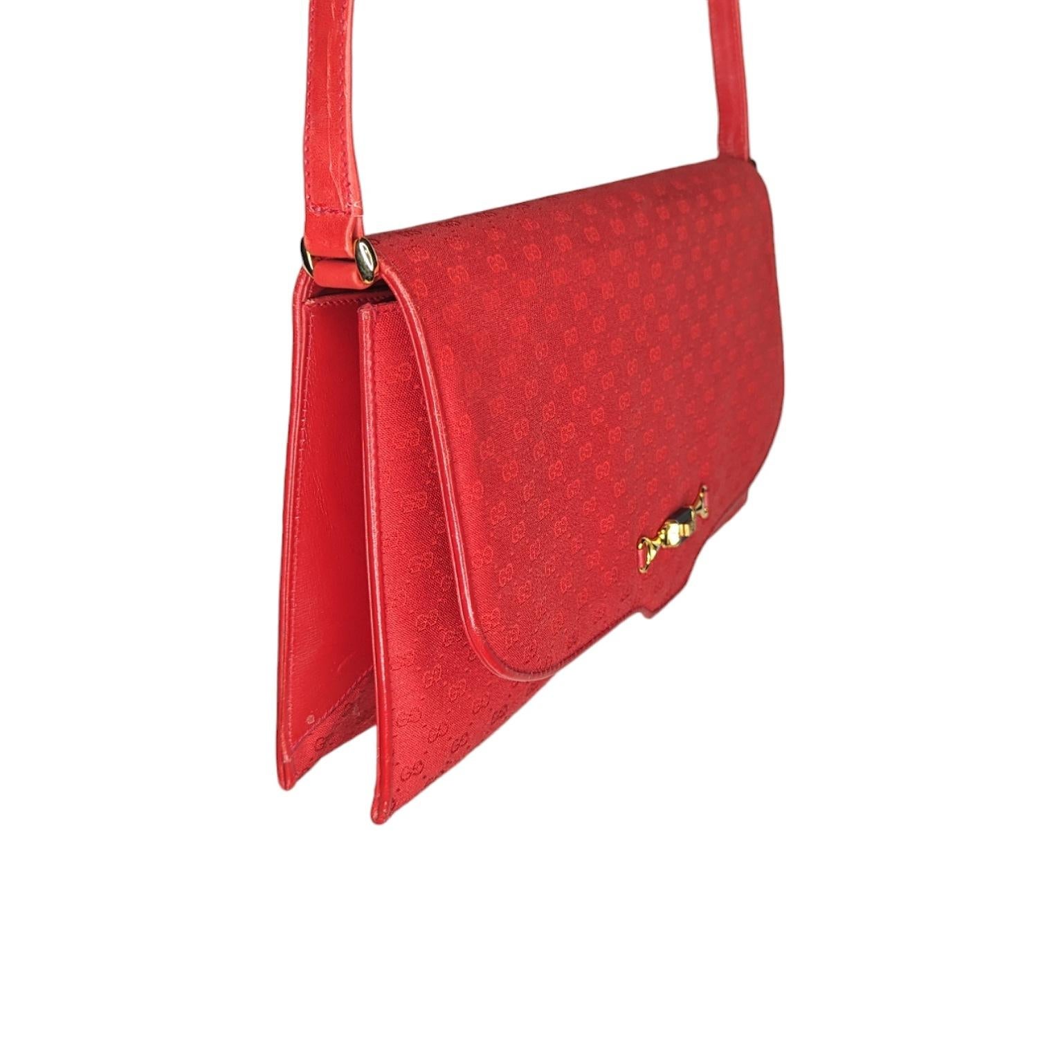 This vintage Gucci shoulder/clutch bag is crafted of GG micro monogram coated canvas with leather trim, gold toned hardware, Horsebit detail, front flap snap closure, a leather interior with a zippered pocket. This Gucci also features a detachable