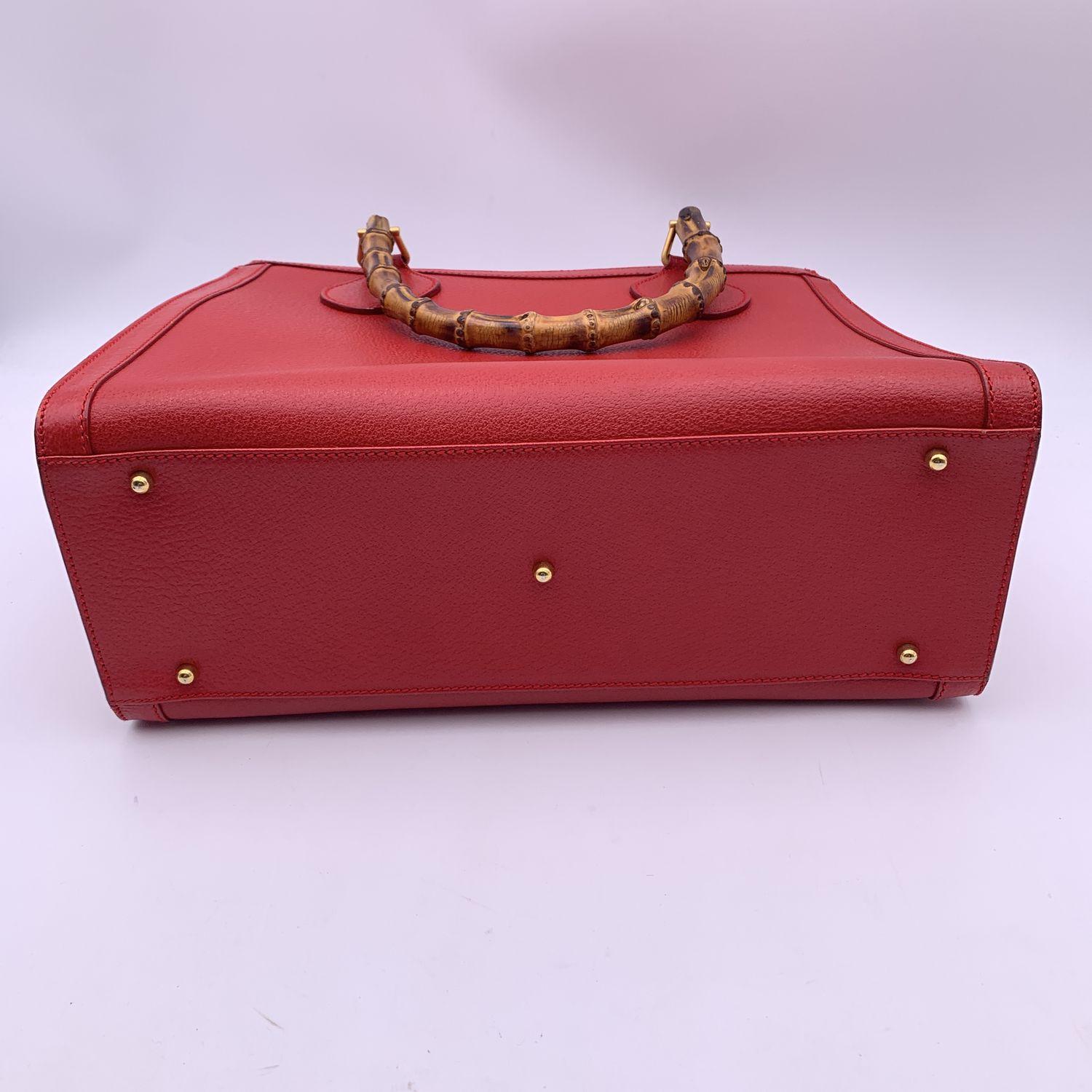 Beautiful Gucci Bamboo tote bag in red leather. Double distinctive Bamboo handle. Princess Diana, was snapped carrying a this model on several occasions. Magnetic button closure on top. 5 bottom feet. Gold metal hardware. 2 main compartments and 1