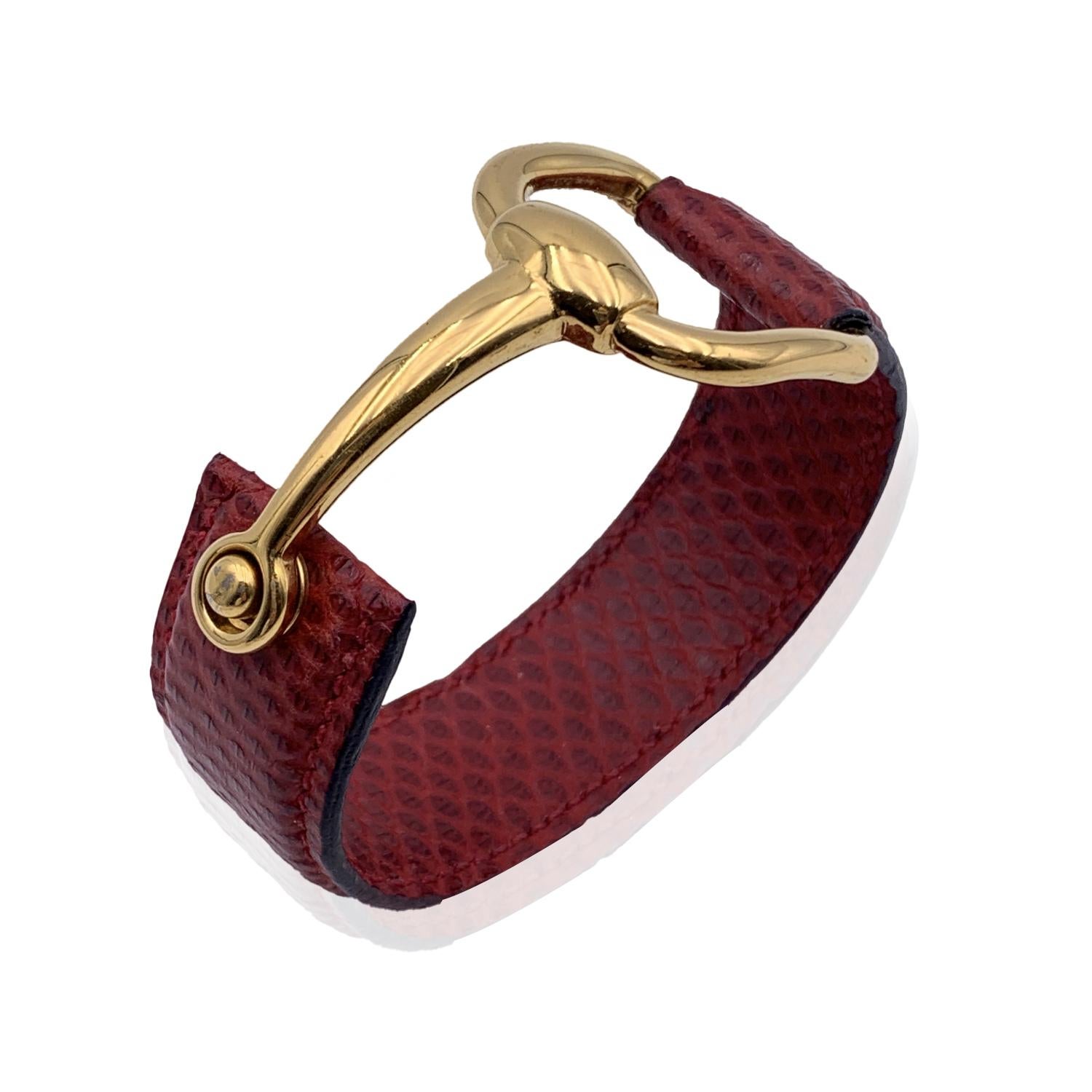 Vintage beautiful cuff bracelet by Gucci. Made in red leather, it features an gold metal half-horsebit. Will fit up to approx. 6.5 inches - 16.5 cm wrist. Width: 0.75 inches - 2 cm. 'Gucci - made in Italy' engraved on the reverse of the