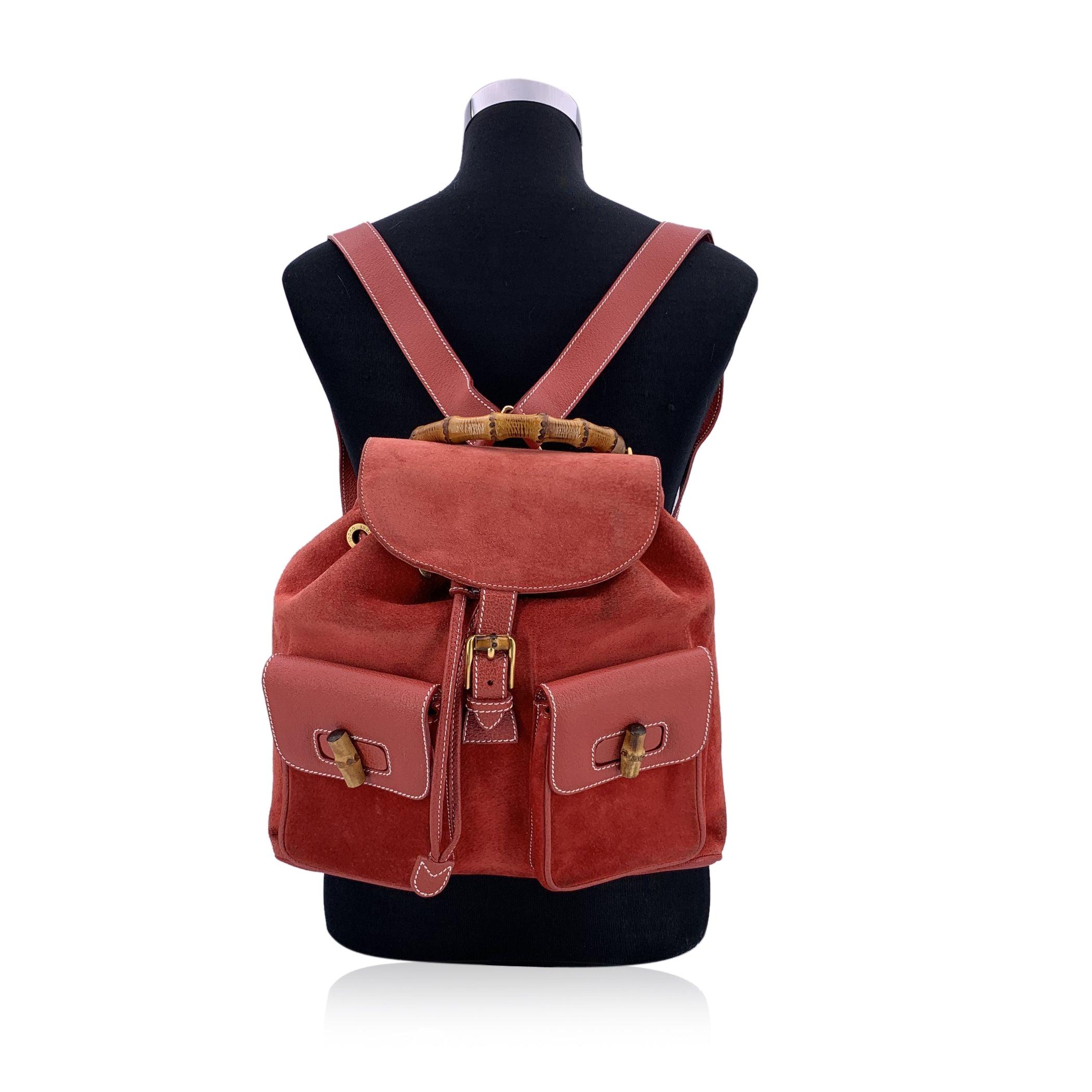 A striking piece from Gucci's storied past, this vintage red suede and leather backpack is a bold yet elegant expression of the brand's signature craftsmanship. The rich red suede is beautifully complemented by smooth leather trim, with the iconic
