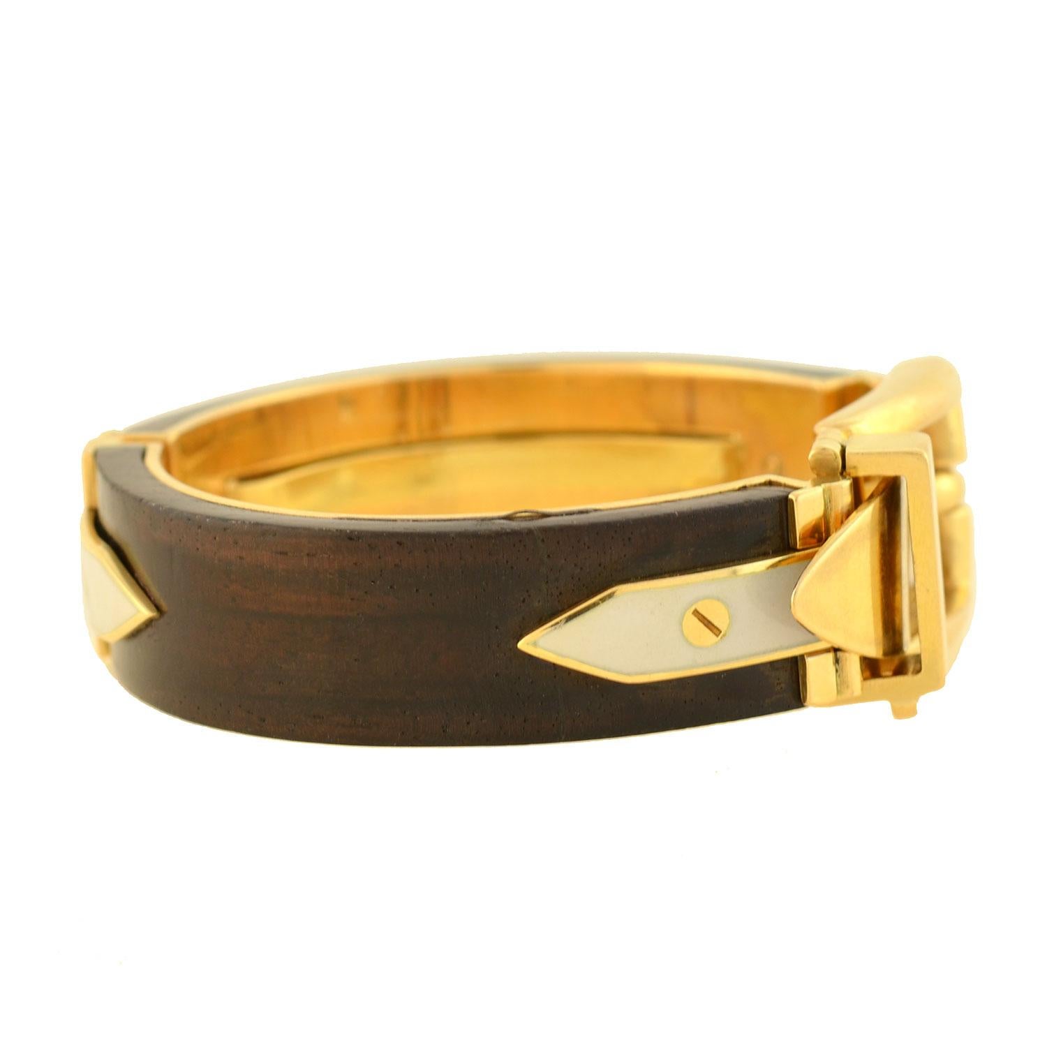 A gorgeous and rare signed Vintage Gucci bangle bracelet from the 1970s era! This 18kt yellow gold piece features a stunning functional buckle design at the front, allowing it to easily open and close and adjust in size. Two curved pieces of