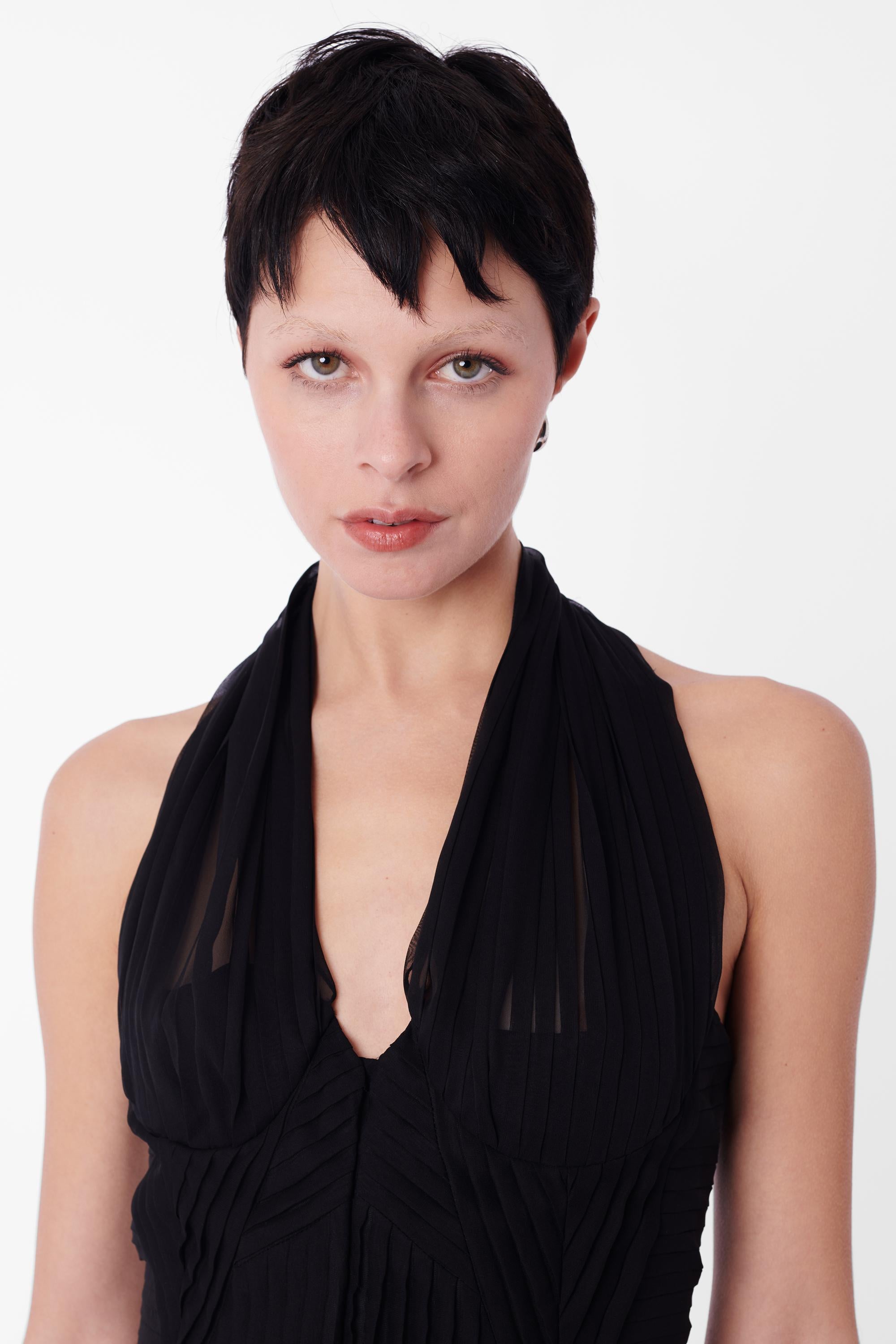 Vintage Gucci by Tom Ford from the Spring/Summer 2003 collection black silk, boned, pleated halterneck corset top. Featuring  a semi sheer halterneck pleated panel and an invisible hook front closure.


Brand: Gucci
Size: UK 10
Color: Black
Modern