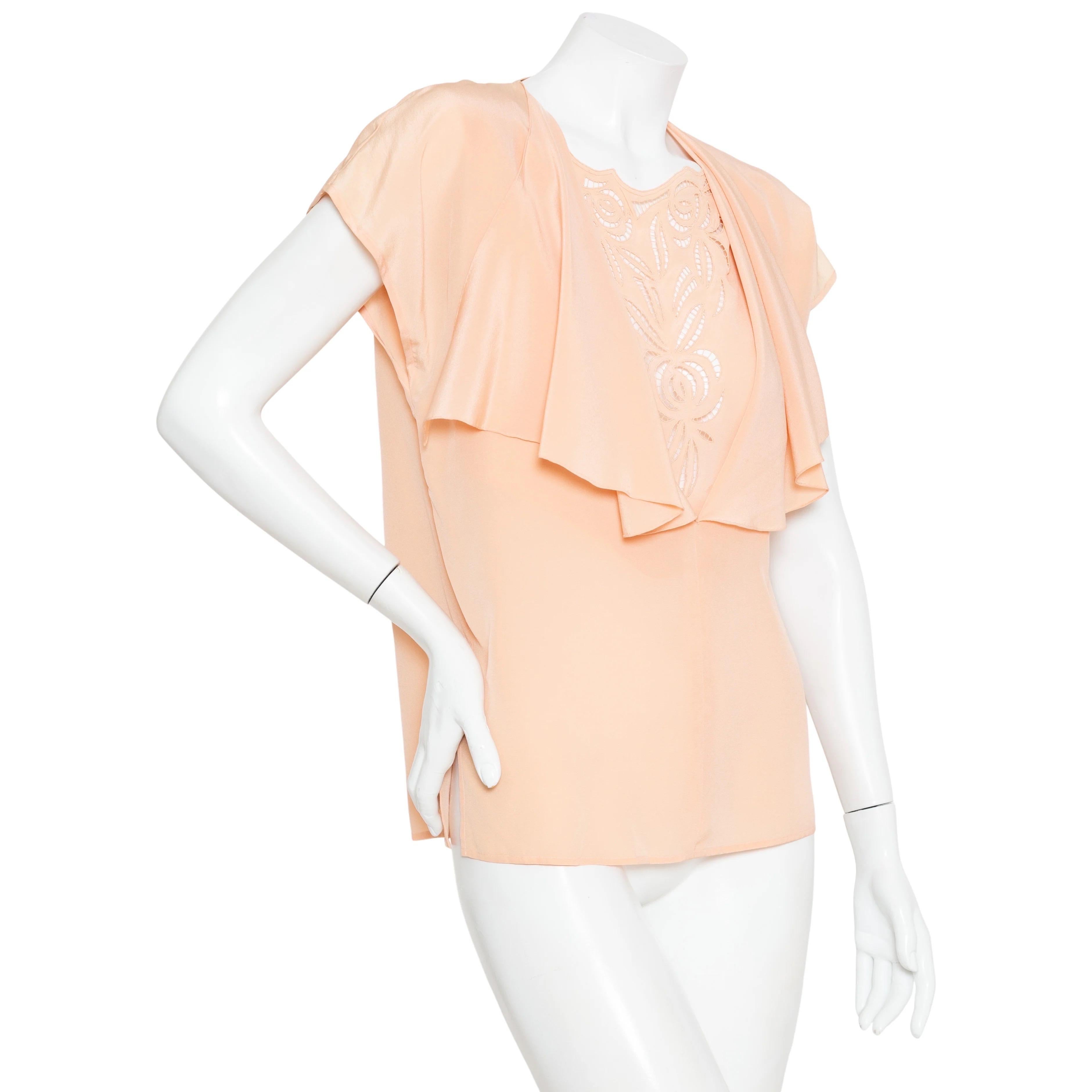Gucci Vintage Peach Silk Cut Out Top

Vintage; circa 1970s
Peach/Pink
Flutter neckline
Ruffled cap sleeves
Cut out floral patterned inlay
Flowy silhouette
Made in Italy
100% silk
Excellent pre-owned vintage condition; little to no signs of wear
Size