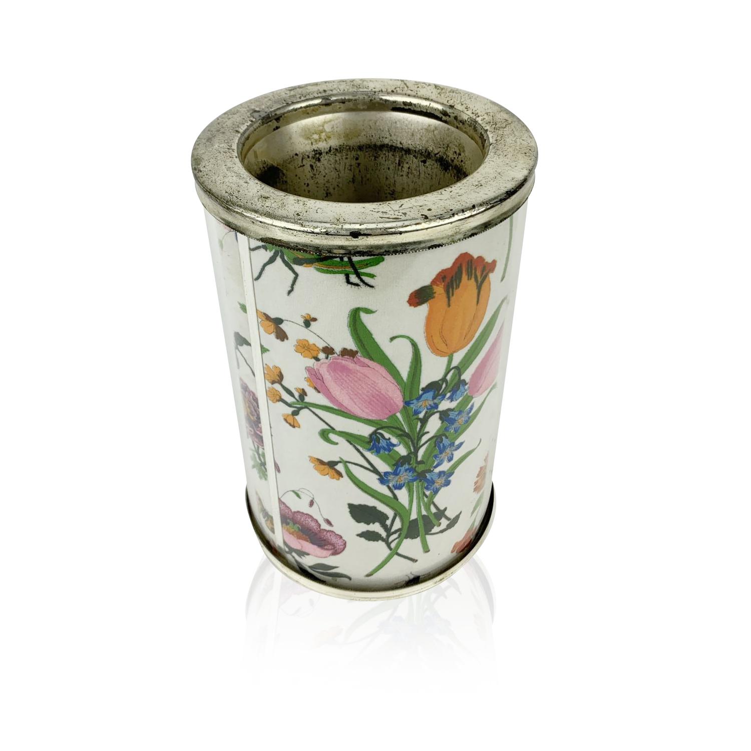 Rare Gucci wine cooler/bottle holder. Made of silver metal and plastic with iconic Flora fabric interposed between the two layers. Marked 'Gucci - Made in Italy' on the bottom. Height: 8. 5 inches - 21,5 cm - Width:6.5 inches - 16,5