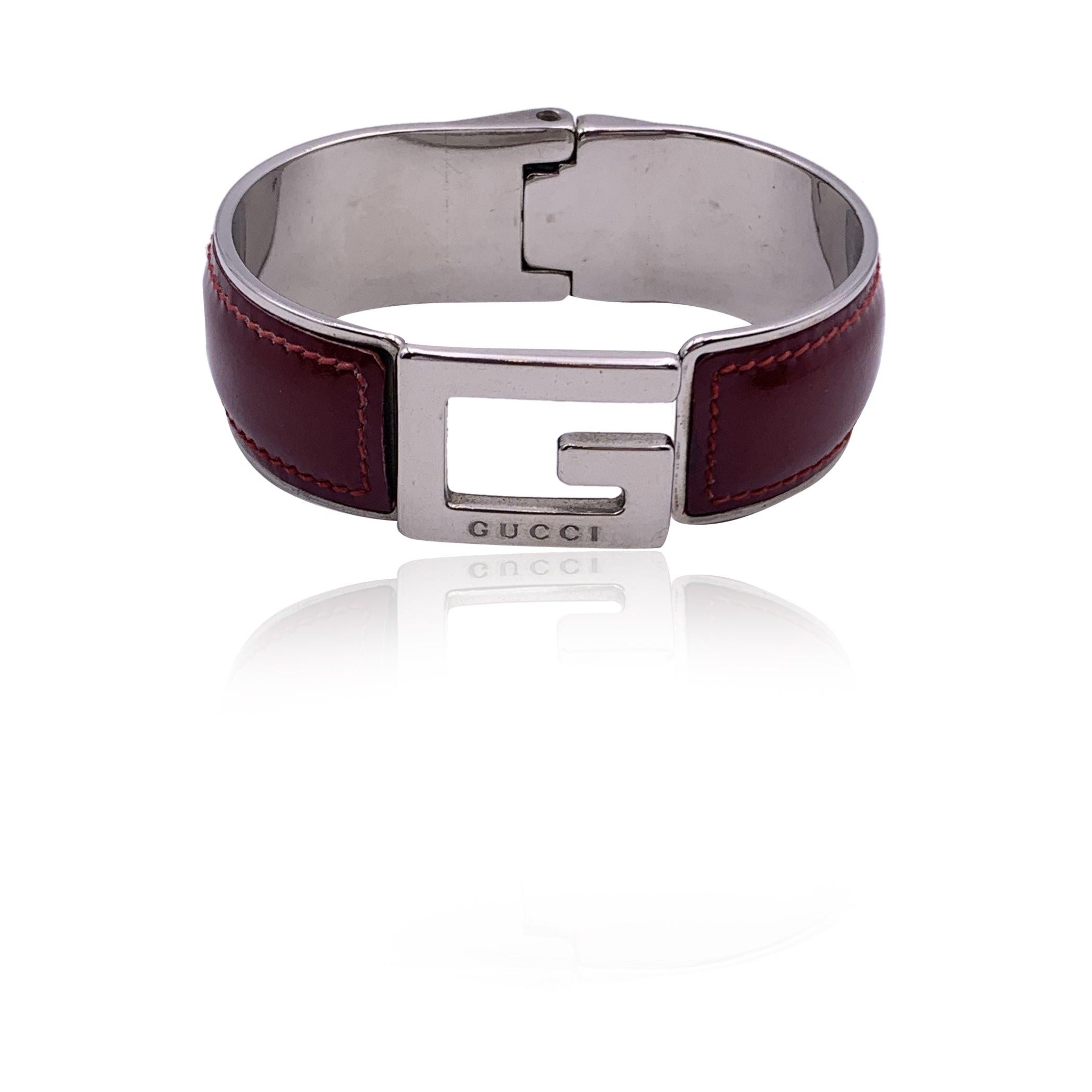 Silver tone metal bangle bracelet with G logo by GUCCI. Red patent leather. Spring hinge for easy wearing. Made in Italy. Max width (internally): 2.5 inches - 6.5 cm Internal circumference: 7 inches - 17.7 cm Condition A - EXCELLENT Used once or