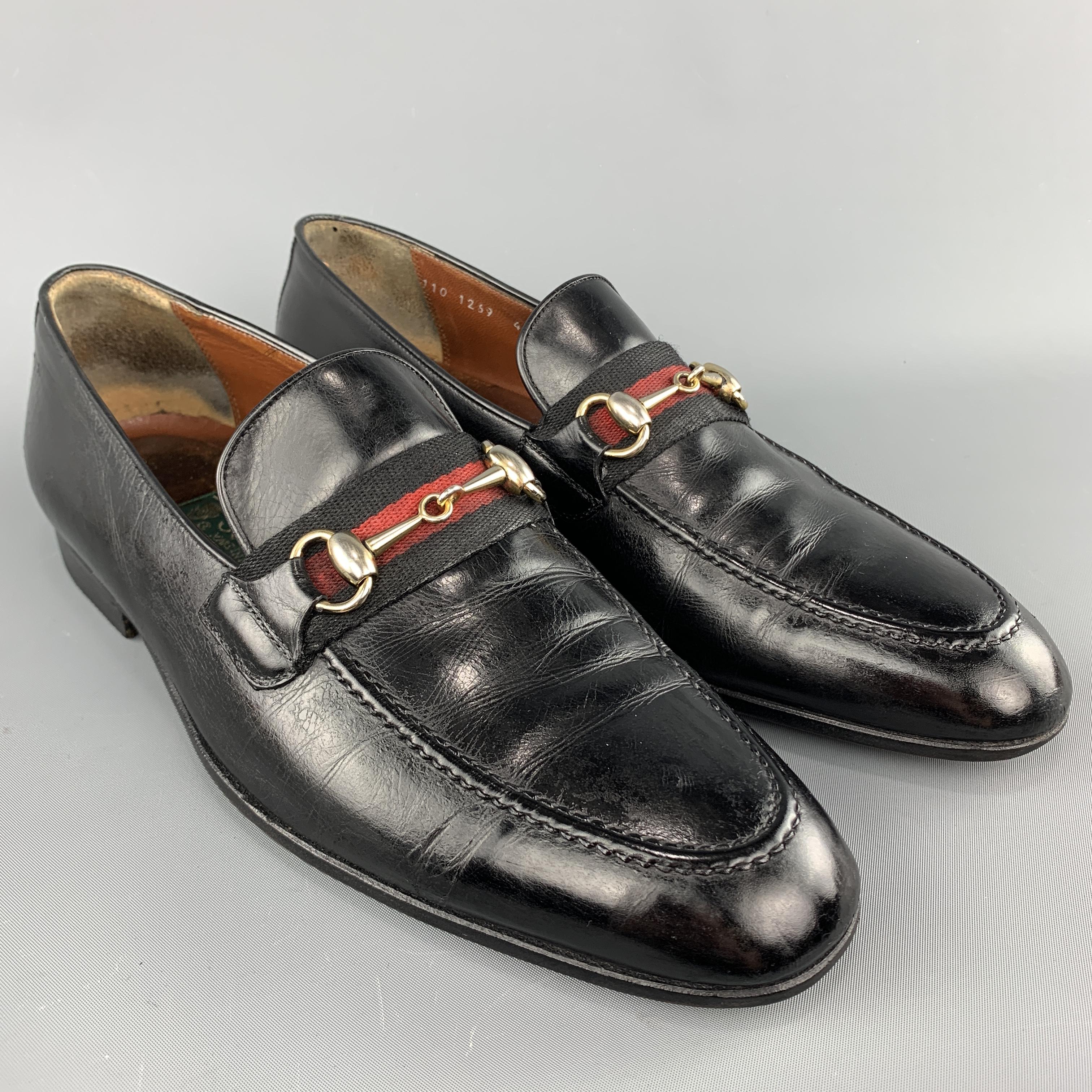 Vintage Gucci loafers come in black leather with a green and red striped webbing strap adorned with gold tone metal horsebit. Wear throughout. As-is. Made in Italy.

Good Vintage Pre-Owned Condition.
Marked: IT 43.5

Outsole: 11.5 x 4 in.