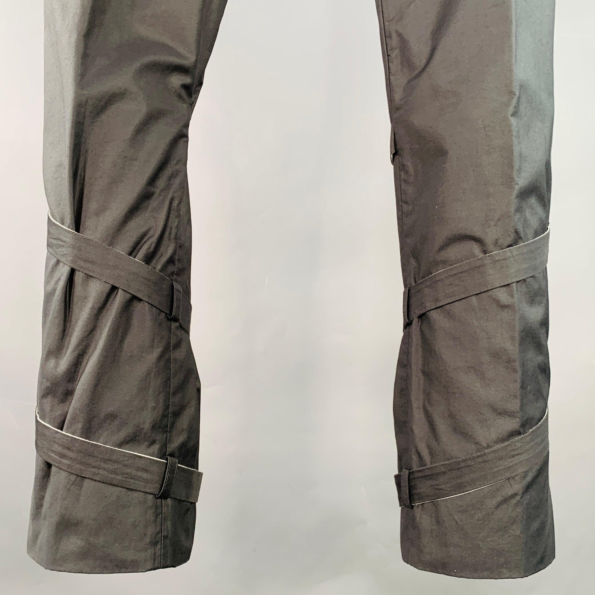 Vintage GUCCI by STEPHANO PILATI 2009 casual pants
in a grey cotton blend fabric featuring a flat front style, super skinny fit, and wrap around bondage strap cuff design. Made in Italy.Very Good Pre-Owned Condition. Marks inside of garment, as is.