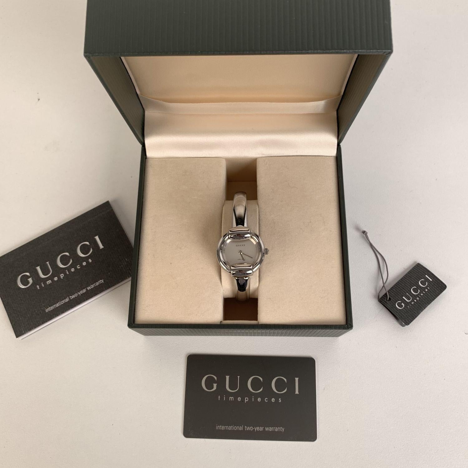 Gucci 1400 L stainless steel wrist watch from the 90s. Stainless steel case. White dial and Sapphire crystal. Swiss Made Quartz movement. Gucci written on face. Water Resistant to 3atm. Clasp closure. Swiss Made. Will fit up to 6 inches - 15,2 cm