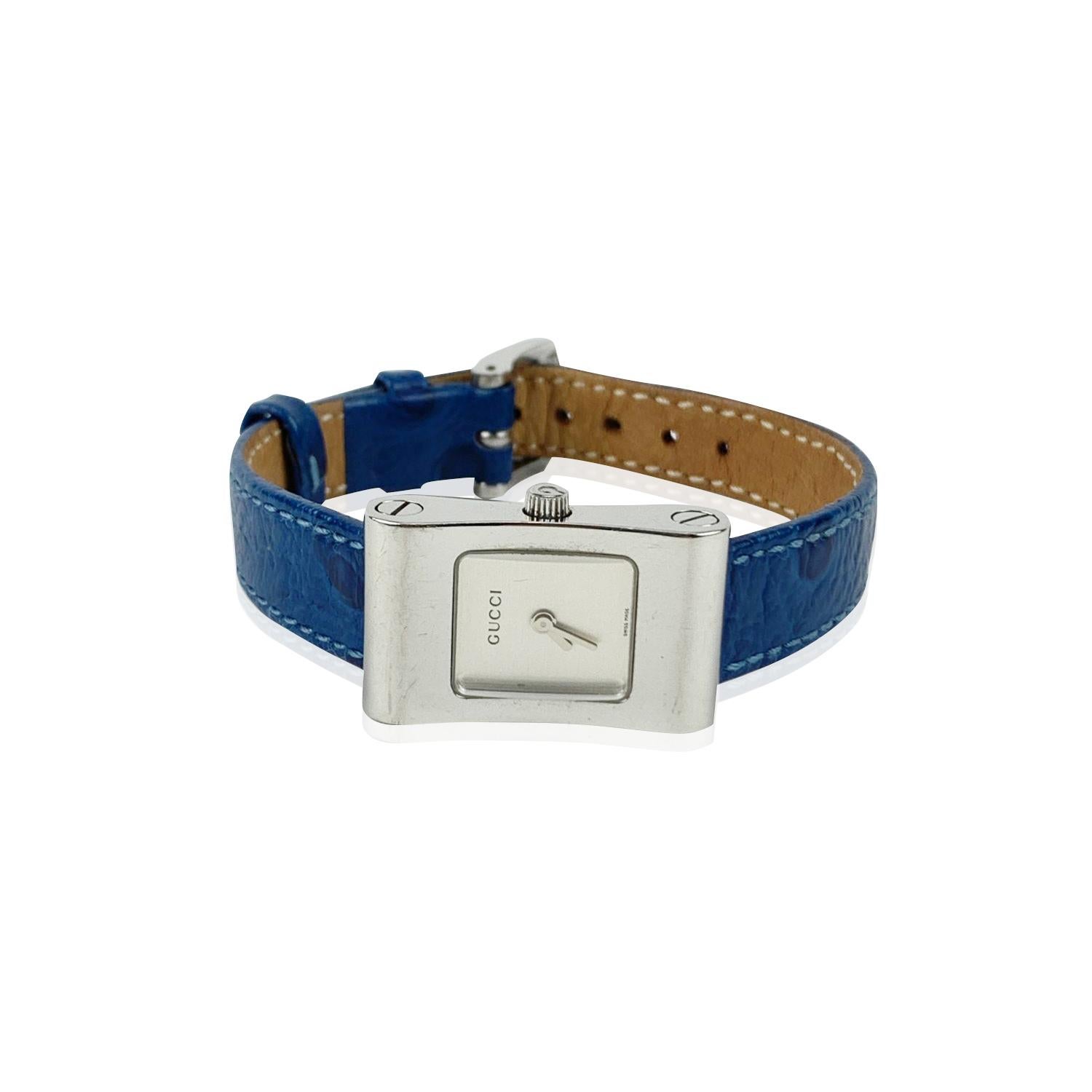 Beautiful vintage wristwatch by GUCCI, Mod. 2300 L. Rectangular silver tone stainless steel case. Swiss Made Quartz Movement. Blue leather wrist strap with 7 holes adjustment. White dial. 'GUCCI' lettering on the dial. Total length: 8 inches - 20.3