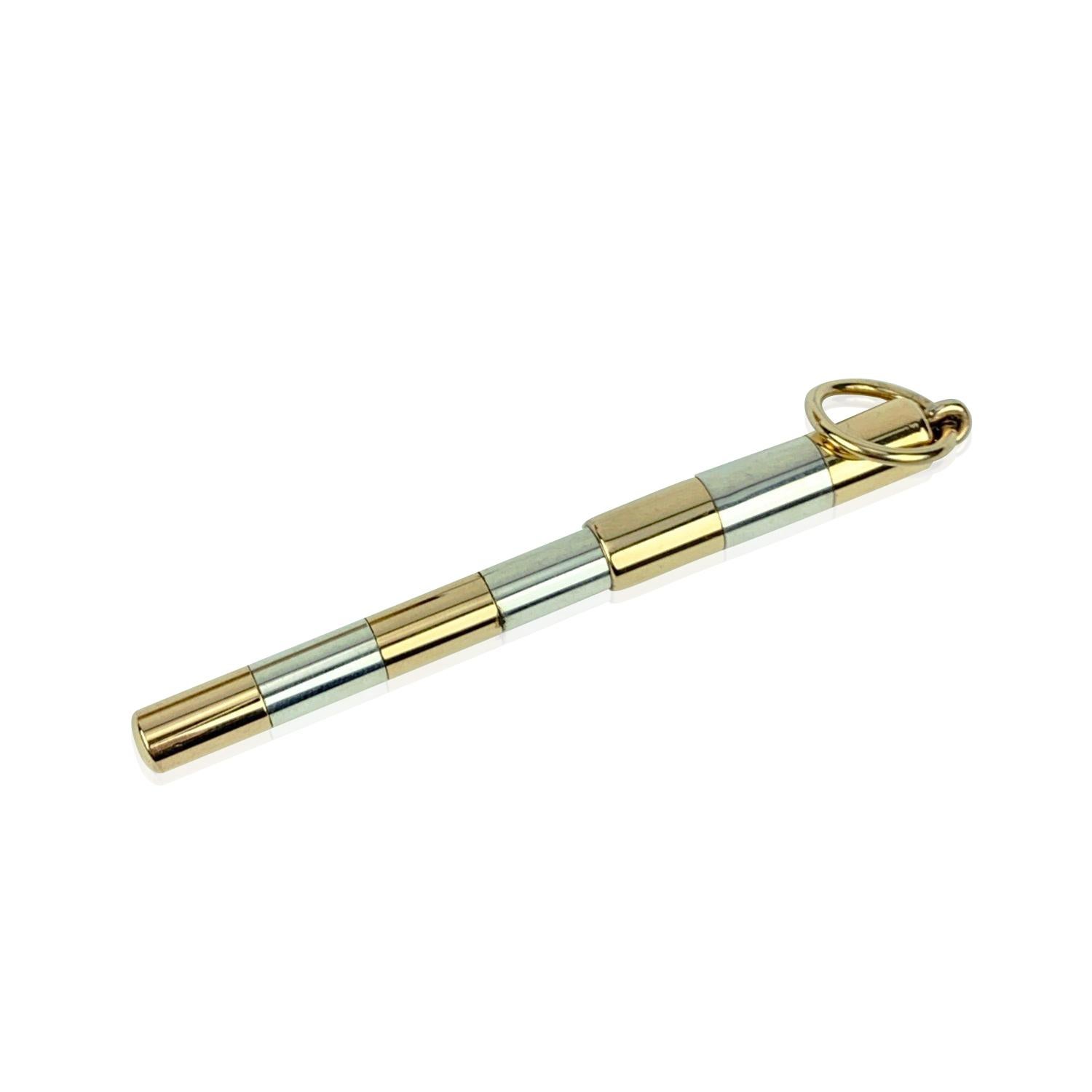 Small vintage ball point pen by Gucci. Made of sterling silver metal with golden details. It features a small ring on the cap that allows you to attach it to a necklace or key ring to always have the pen with you. Total length: 2.75 inches - 7 cm.