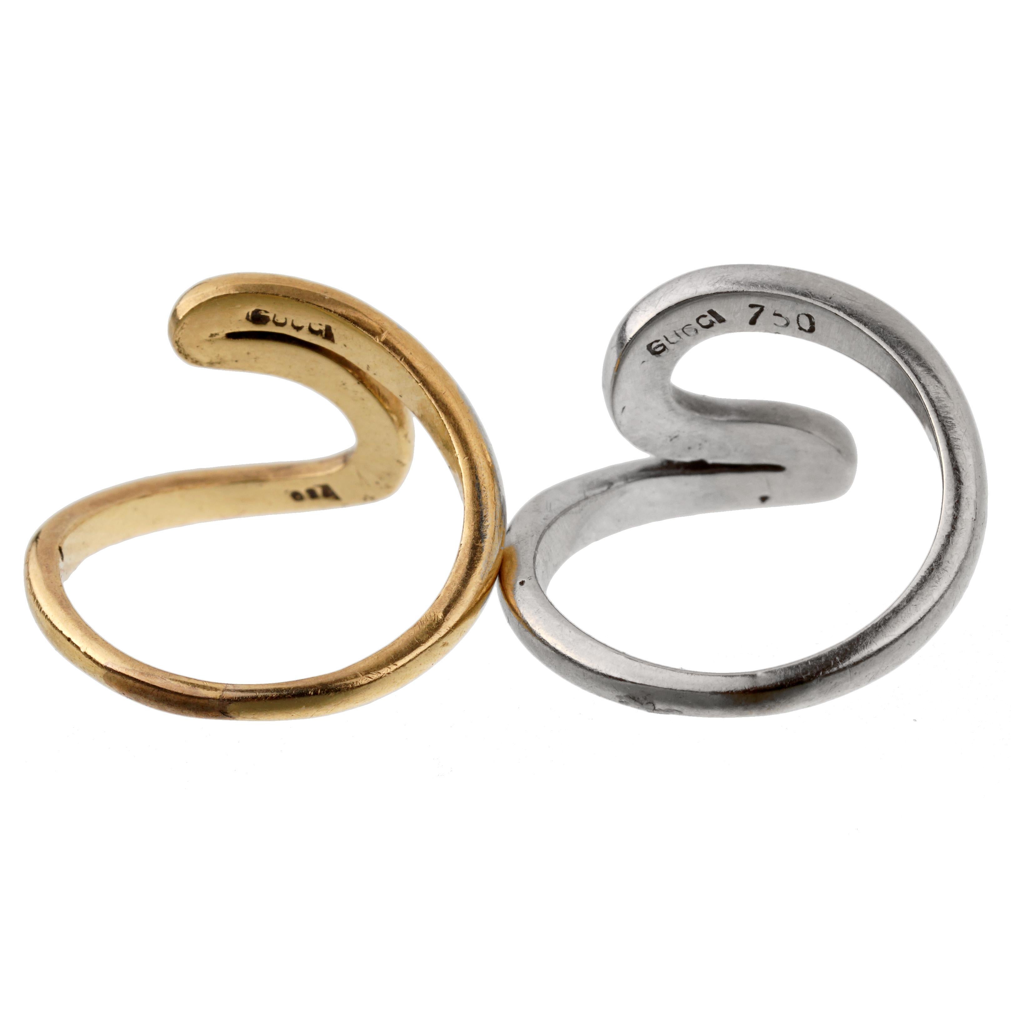 A set of vintage Gucci swirl rings one in 18k yellow gold and one in 18k white gold. The rings can be worn together and or separately. The rings measure a size 3 1/4 and can be resized if needed.