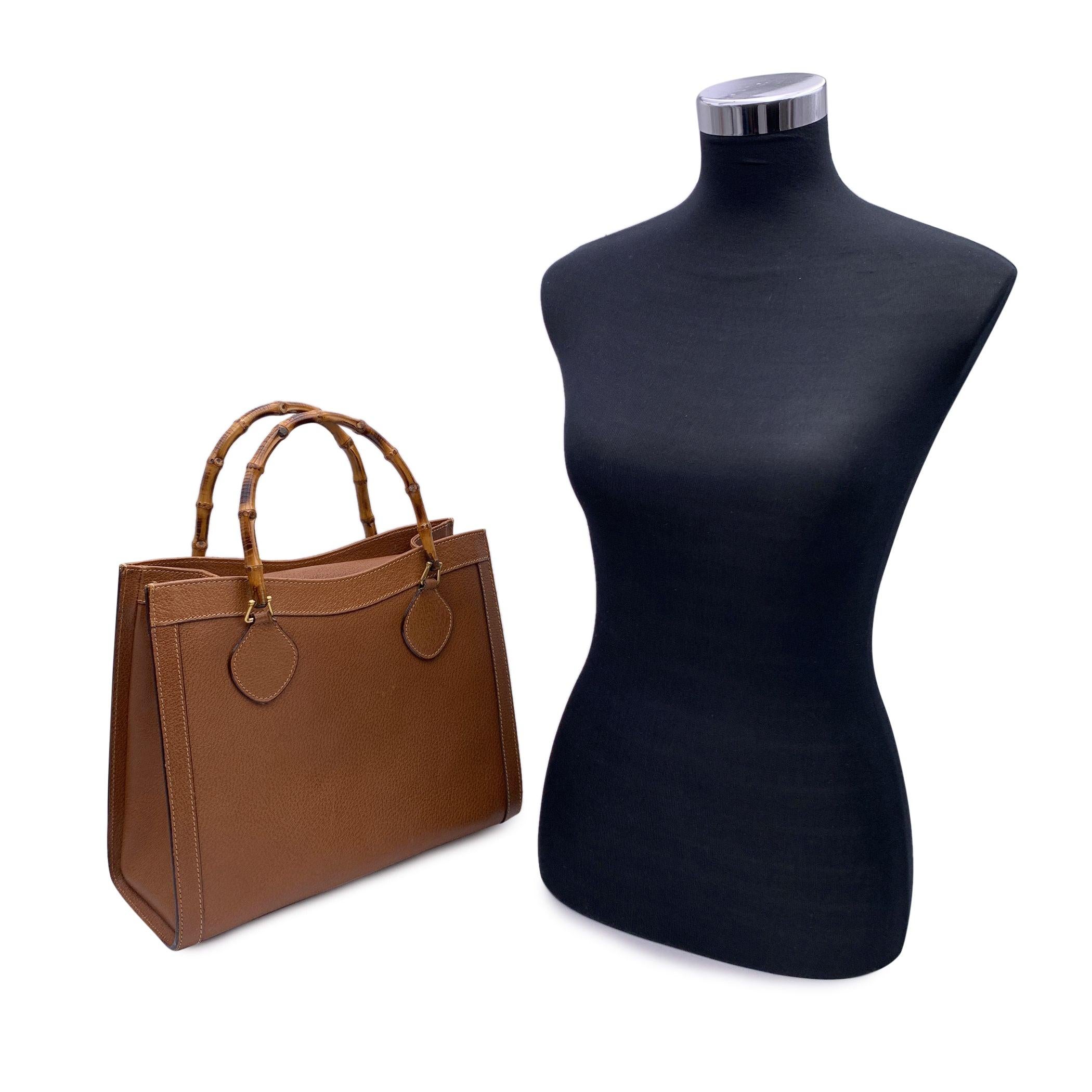 Beautiful Gucci Bamboo tote bag in tan brown leather. Double distinctive Bamboo handle. Princess Diana, was snapped carrying a this model on several occasions. Magnetic button closure on top. 5 bottom feet. Gold metal hardware. 2 main compartments