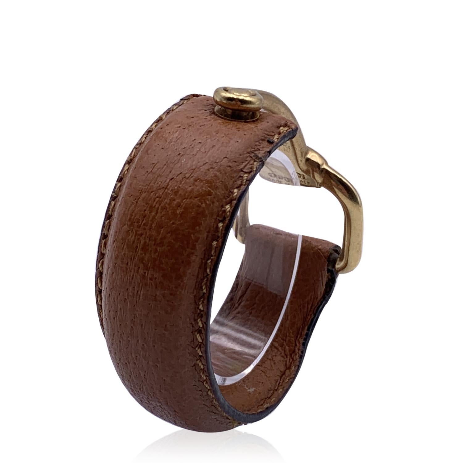 Vintage beautiful cuff bracelet by Gucci. Made in tan leather, it features an gold metal half-horsebit. Will fit up to approx. 6.5 inches - 16.5 cm wrist. Width: 0.75 inches - 2 cm. 'Gucci - made in Italy' engraved on the reverse of the