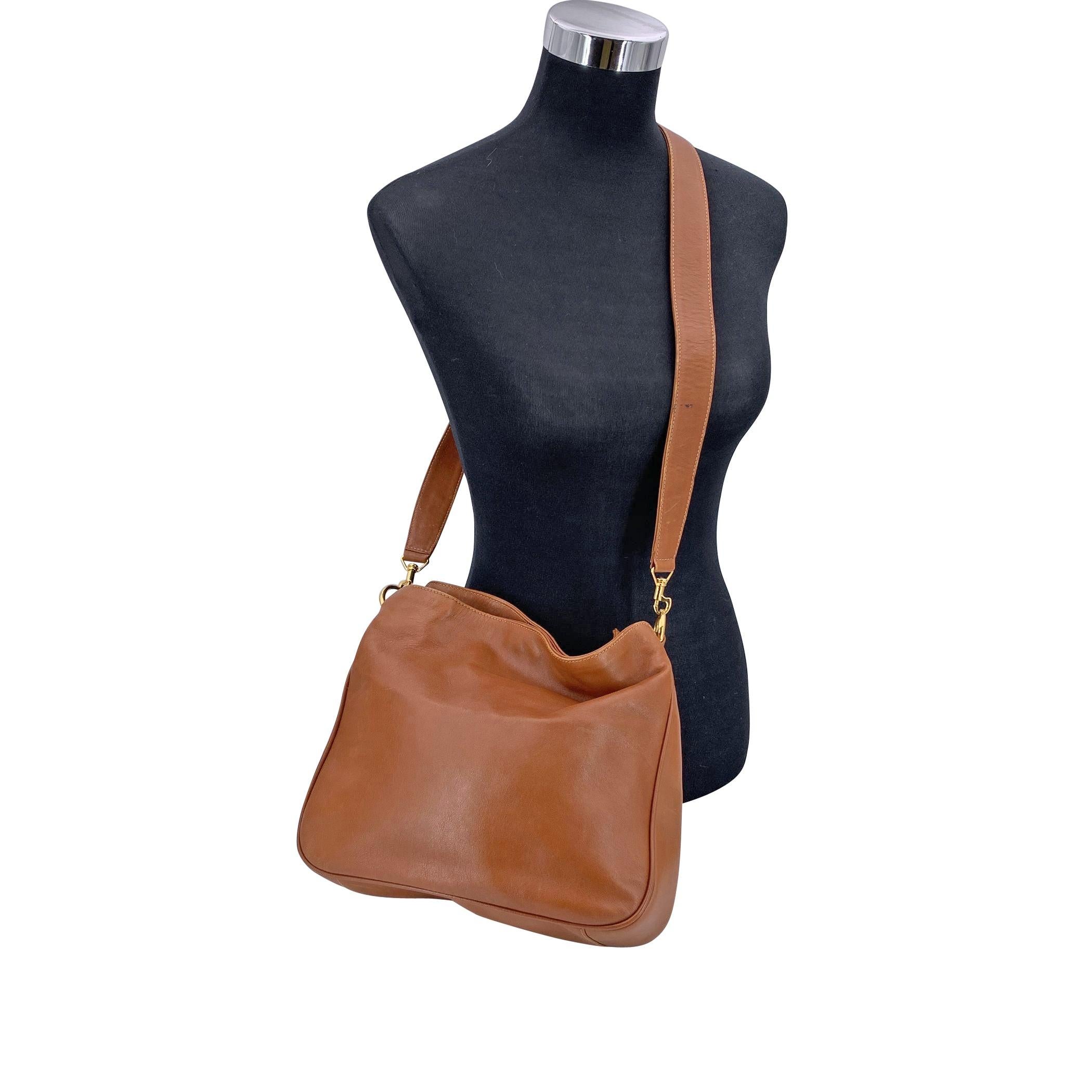 A timeless piece from Gucci's legacy of craftsmanship, this beautiful tan leather hobo bag exudes quiet elegance and vintage charm. Its sculptural bamboo loop handle - an iconic nod to the brand's heritage - adds a touch of organic sophistication,