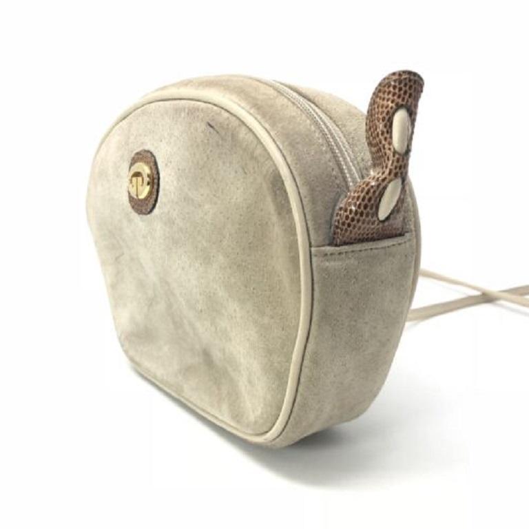 This vintage Gucci suede crossbody bag is perfect for carrying things around while on the go. Roomy enough for a wallet, keys, and other necessities but not too large to become weighed down and heavy. This bag features a suede exterior with leather