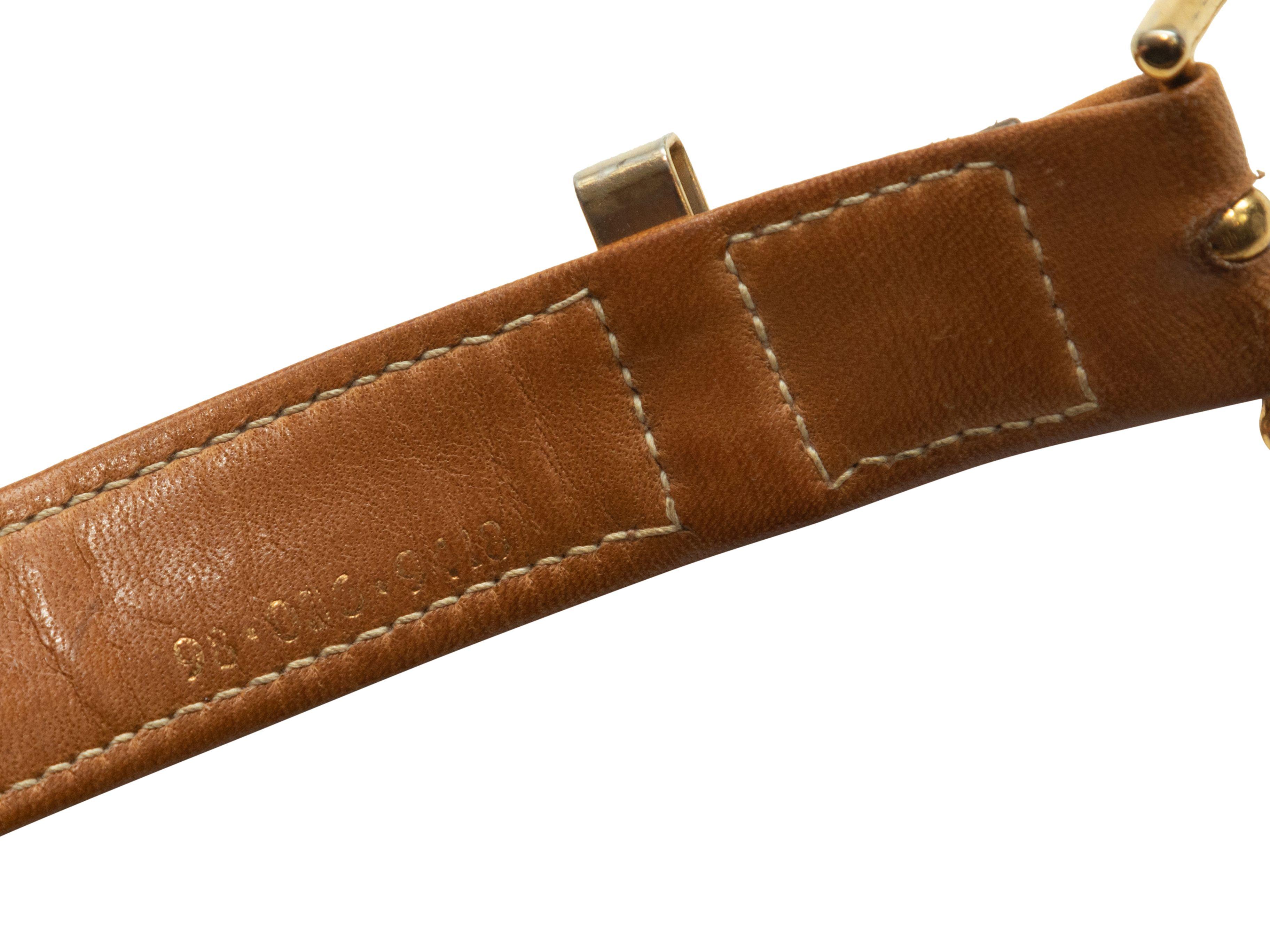 Product Details: Vintage taupe leather belt by Gucci. Green and red web stitching detail. Gold-tone buckle closure. 1
