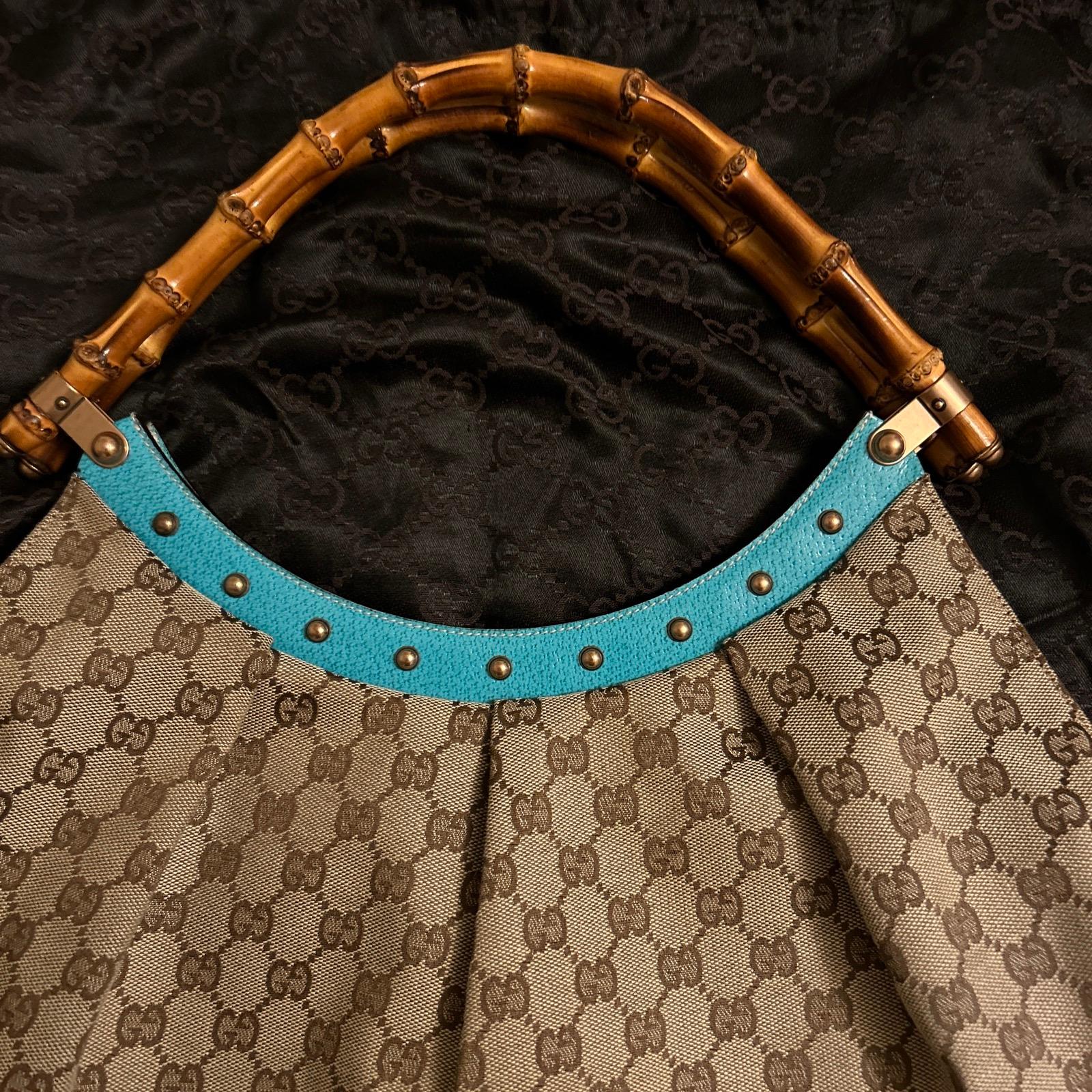 fabulous Gucci monogram bag.

Designed by Tom Ford for Gucci in the 90s.

In superb condition . Outside is very good and inside is beautifully clean. 

This bag has amazing  bamboo top handles with bronze/ gold coloured metal hardware. Fabulous