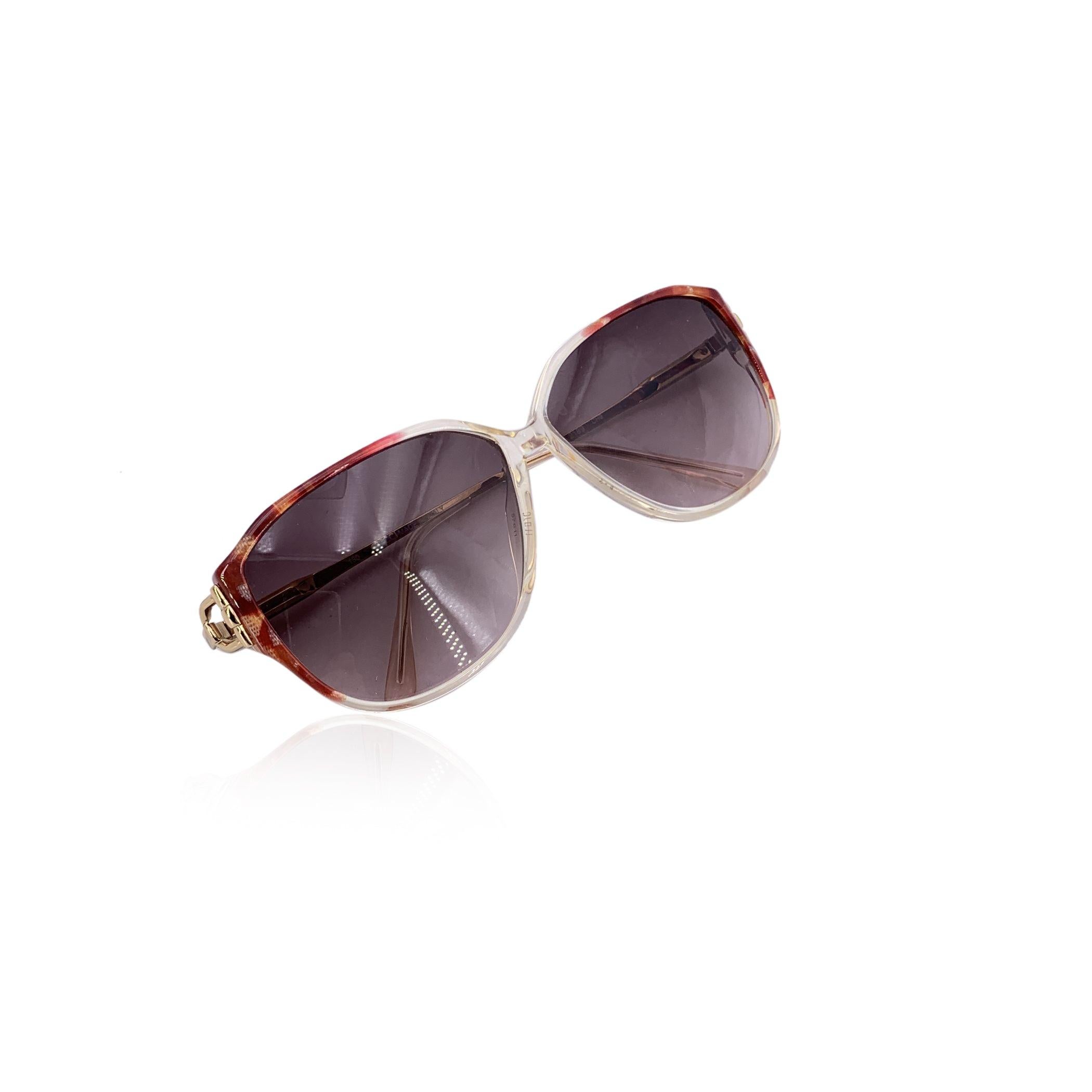 A bold echo from the glamorous 1980s, these Gucci vintage clear and brown sunglasses, model GG 2189, are a striking celebration of retro Italian flair. With their dramatic butterfly silhouette and vibrant color contrast-crisp white frames paired