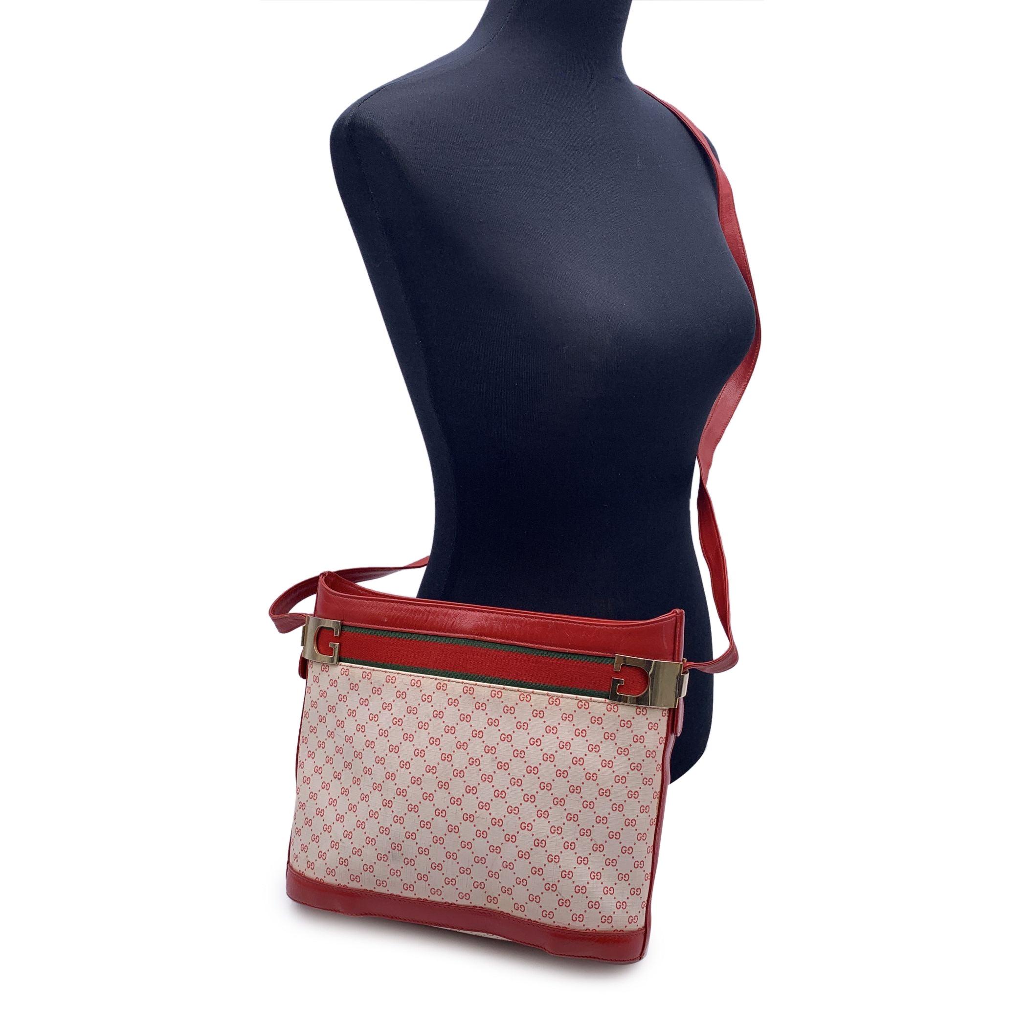This beautiful Bag will come with a Certificate of Authenticity provided by Entrupy. The certificate will be provided at no further cost. Vintage Gucci bucket shoulder bag crafted in white and red monogram canvas with red genuine leather trim and