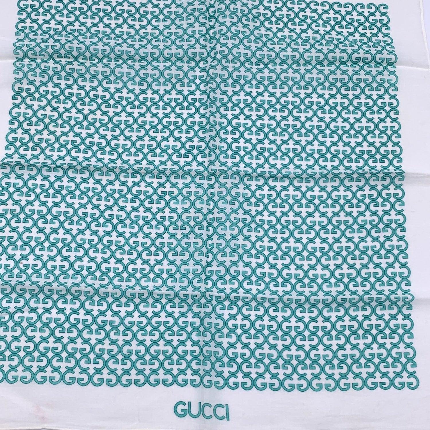 Vintage neck scarf by GUCCI. 100% Cotton. Green GG logo pattern with white borders. 'Gucci' signature printed on the lower center border. Approx. Measurements: 16.5 x 17 inches - 41.9 x 43.2 cm Details MATERIAL: Cotton COLOR: Green MODEL: n.a.