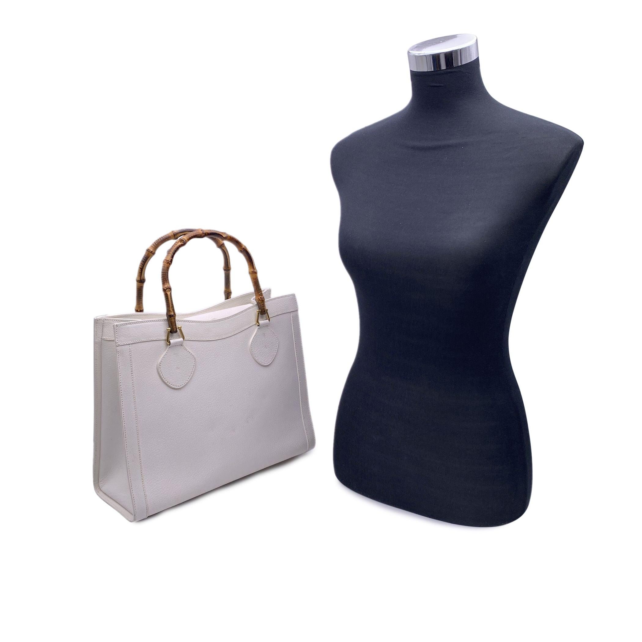 Beautiful Gucci Bamboo tote bag in white leather. Double distinctive Bamboo handle. Princess Diana, was snapped carrying a this model on several occasions. Magnetic button closure on top. 5 bottom feet. Gold metal hardware. 2 main compartments and 1