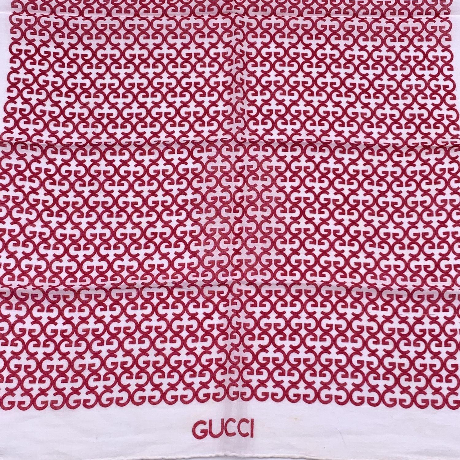 Vintage neck scarf by GUCCI. 100% Cotton. Magenta GG logo pattern with white borders. 'Gucci' signature printed on the lower center border. Approx. Measurements: 15 x 18 inches - 38.1 x 45.7cm Details MATERIAL: Cotton COLOR: Red MODEL: n.a. GENDER: