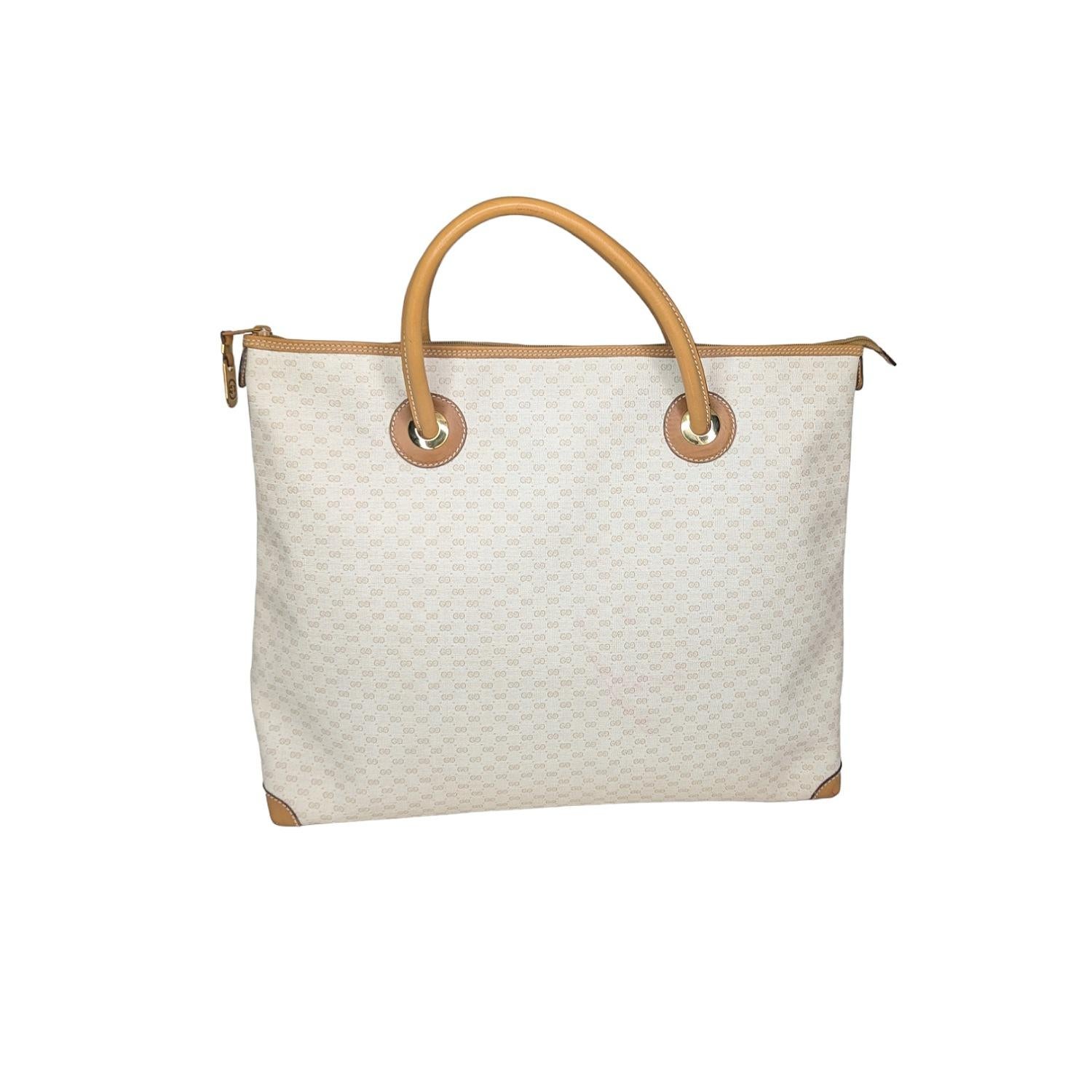 Up for sale; Gucci Vintage White Micro GG Tote. This vintage tote bag was crafted from GG Micro canvas in white with caramel leather trim embellishments and gold-tone hardware. It features a spacious interior with a zippered closure to keep your