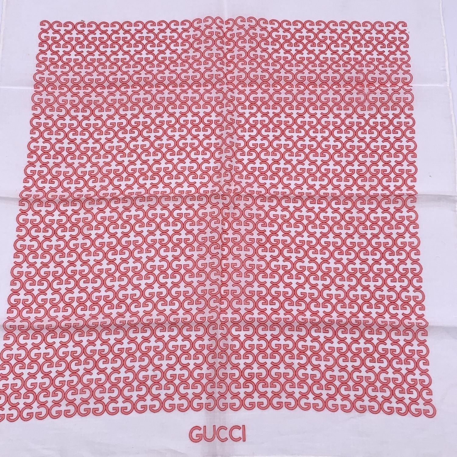 Vintage neck scarf by GUCCI. 100% Cotton. Pink GG logo pattern with white borders. 'Gucci' signature printed on the lower center border. Approx. Measurements: 16.5 x 17 inches - 41.9 x 43.2 cm Details MATERIAL: Cotton COLOR: Pink MODEL: n.a. GENDER: