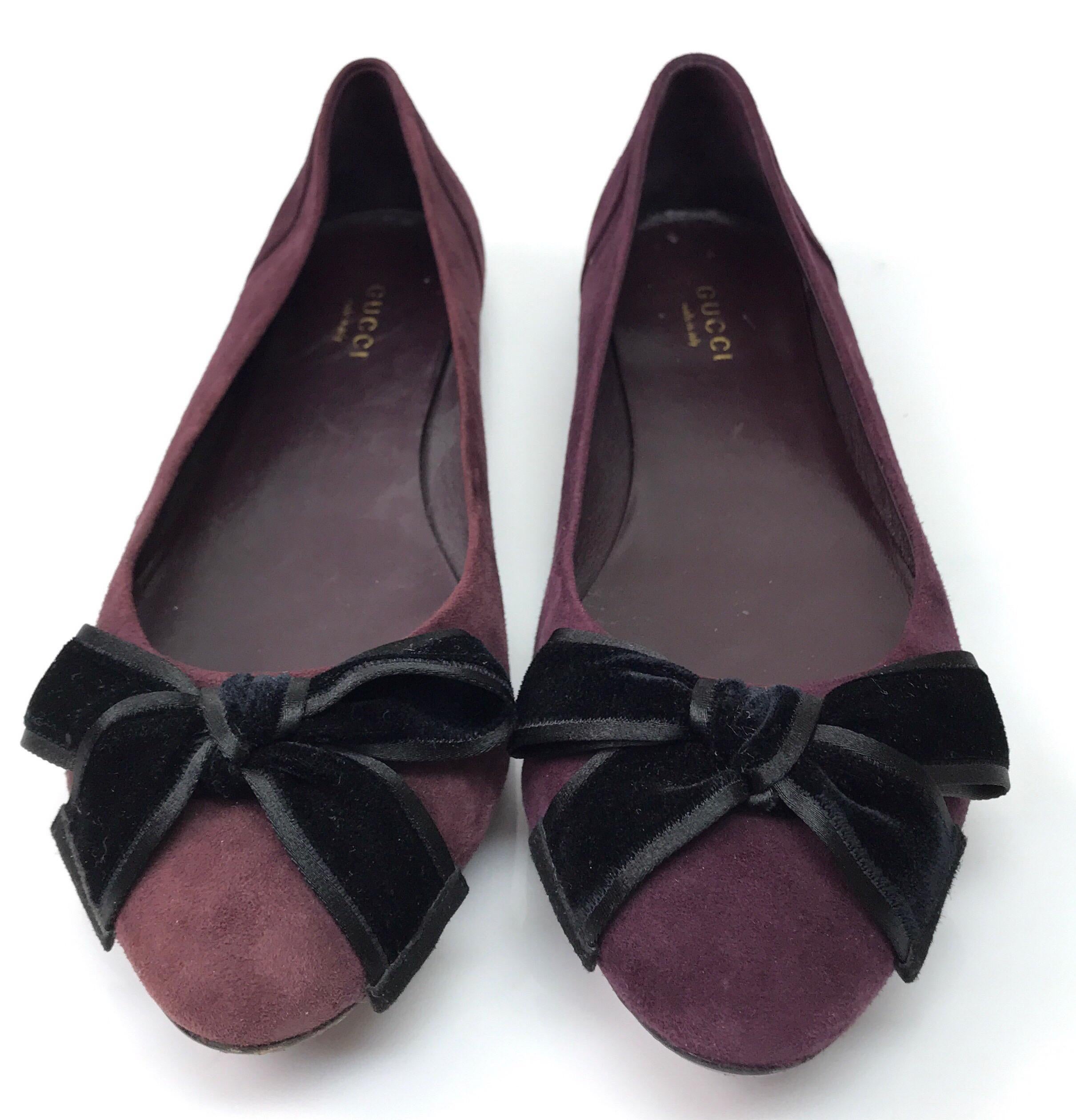Gucci Viola Purple Suede Flats with Velvet Bow - 38.5. These stunning Gucci flats are in great condition. They show minor wear on the bottom of the shoe. They are made of purple suede throughout and have a black velvet bow on the toe. The front of