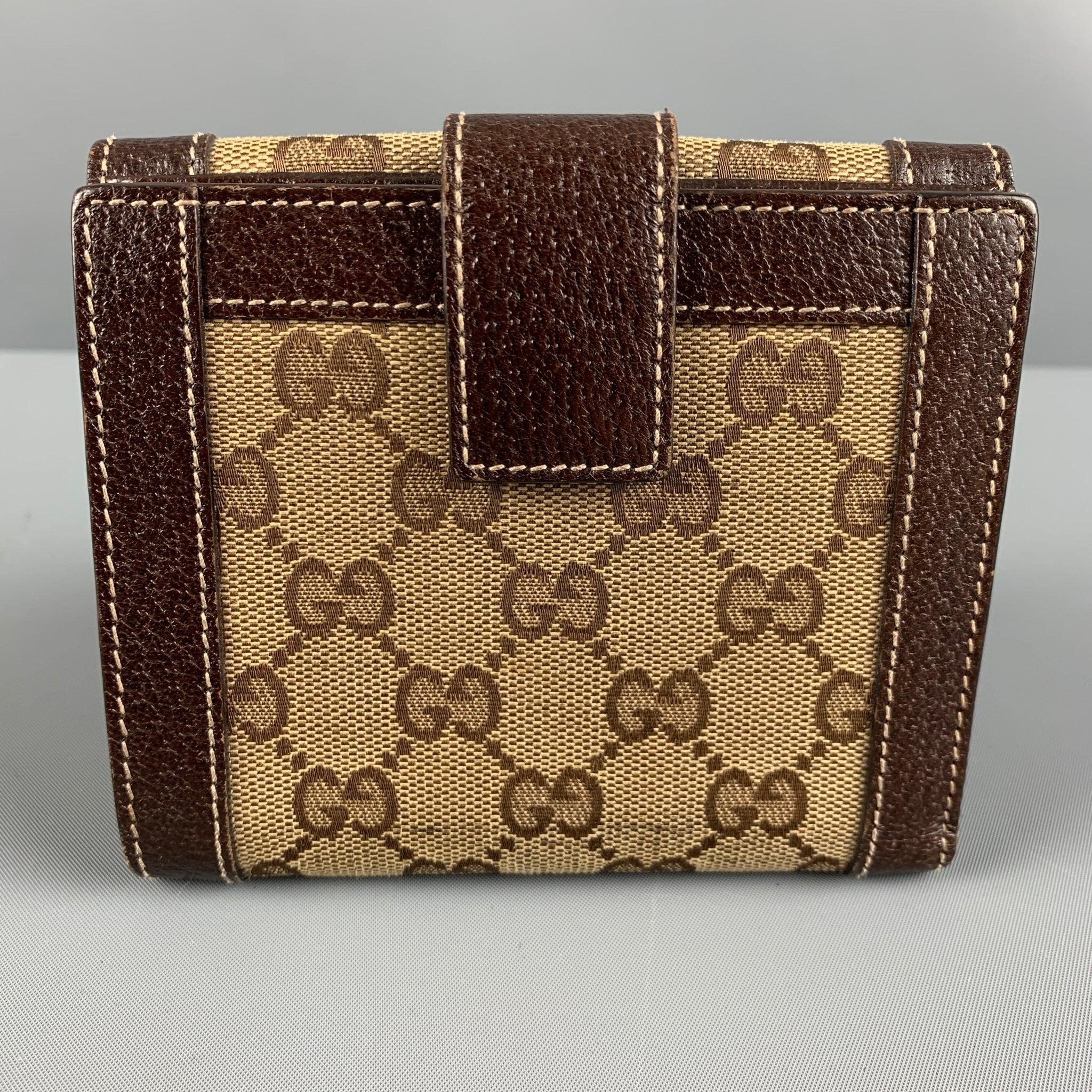 GUCCI VINTAGE wallet comes in a brown and beige GG monogram leather featuring a flap coin pocket, inner slots and snap button closure. Made in Italy.Very Good Pre-Owned Condition. Minor Signs of Wear. 

Measurements: 
  Length: 5 inches Height: 4.5