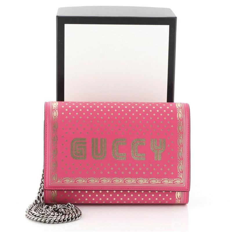 This Gucci Wallet on Chain Limited Edition Printed Leather, crafted from pink printed leather, features chain link strap and gunmetal-tone hardware. Its snap closure opens to a pink fabric and leather interior with multiple card slots and zip