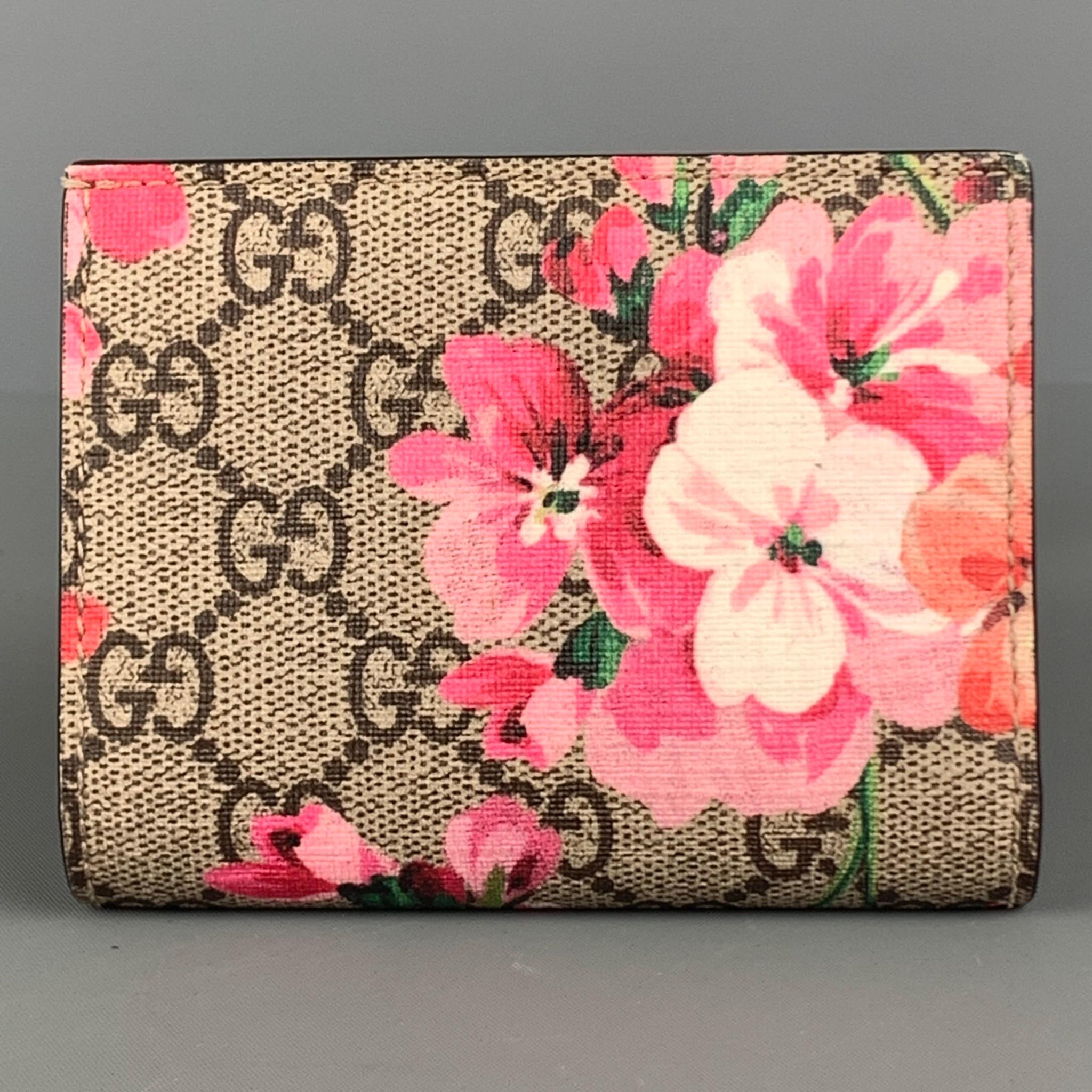 GUCCI wallet comes in a brown and pink GG monogram leather featuring a supreme blooms flowers design, inner slots and snap button closure. Made in Italy.

Very Good Pre-Owned Condition. Minor Signs of Wear.

Measurements:

Length: 4.25 in.
Height: