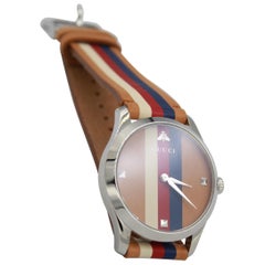 Gucci watch in brown, blue, red and white leather.