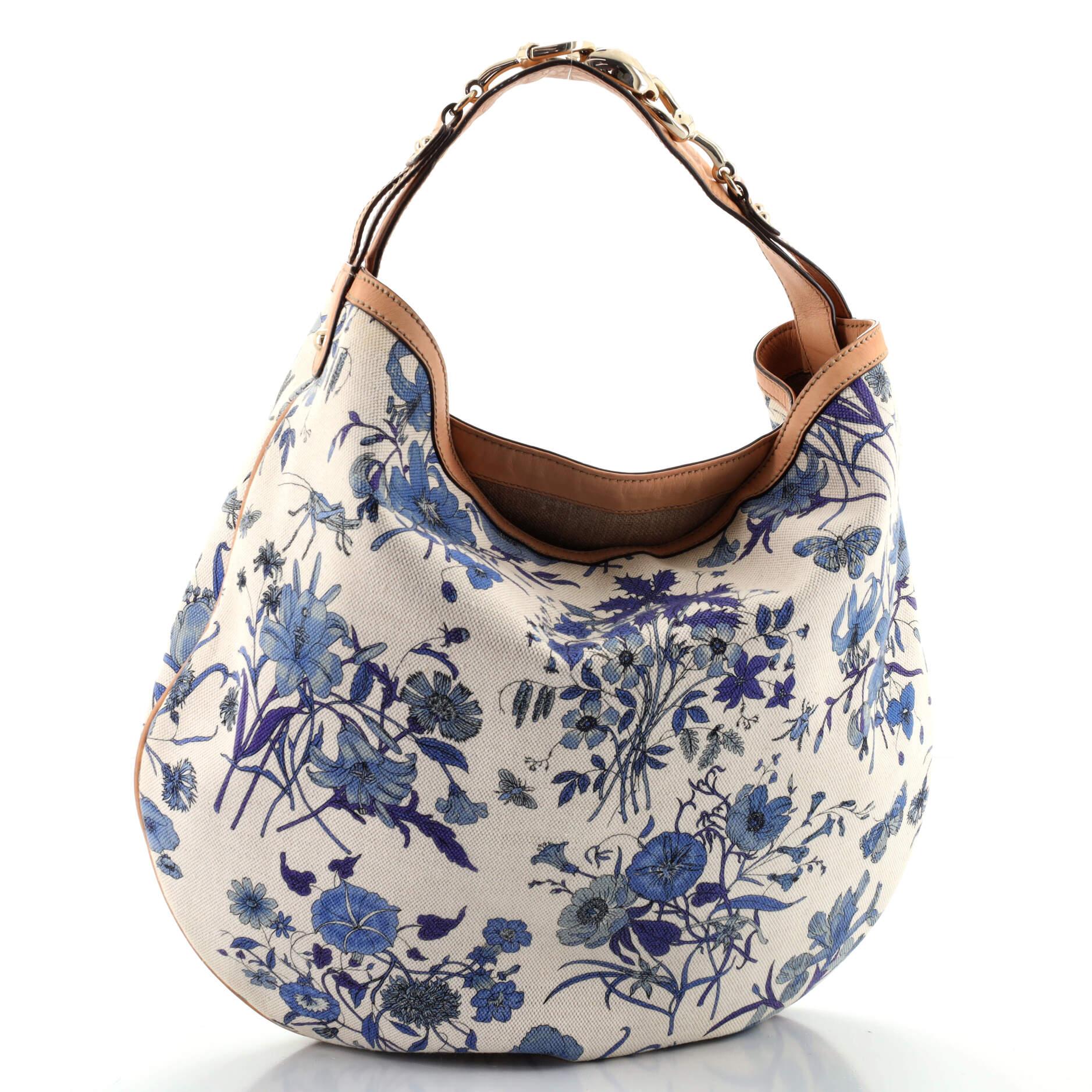 Gucci Wave Hobo Flora Canvas. Minor wear on exterior, minor darkening, scuffs and marks on leather trims and handle. Peeling on handle base wax edges, scratches on hardware. 

78741MSC