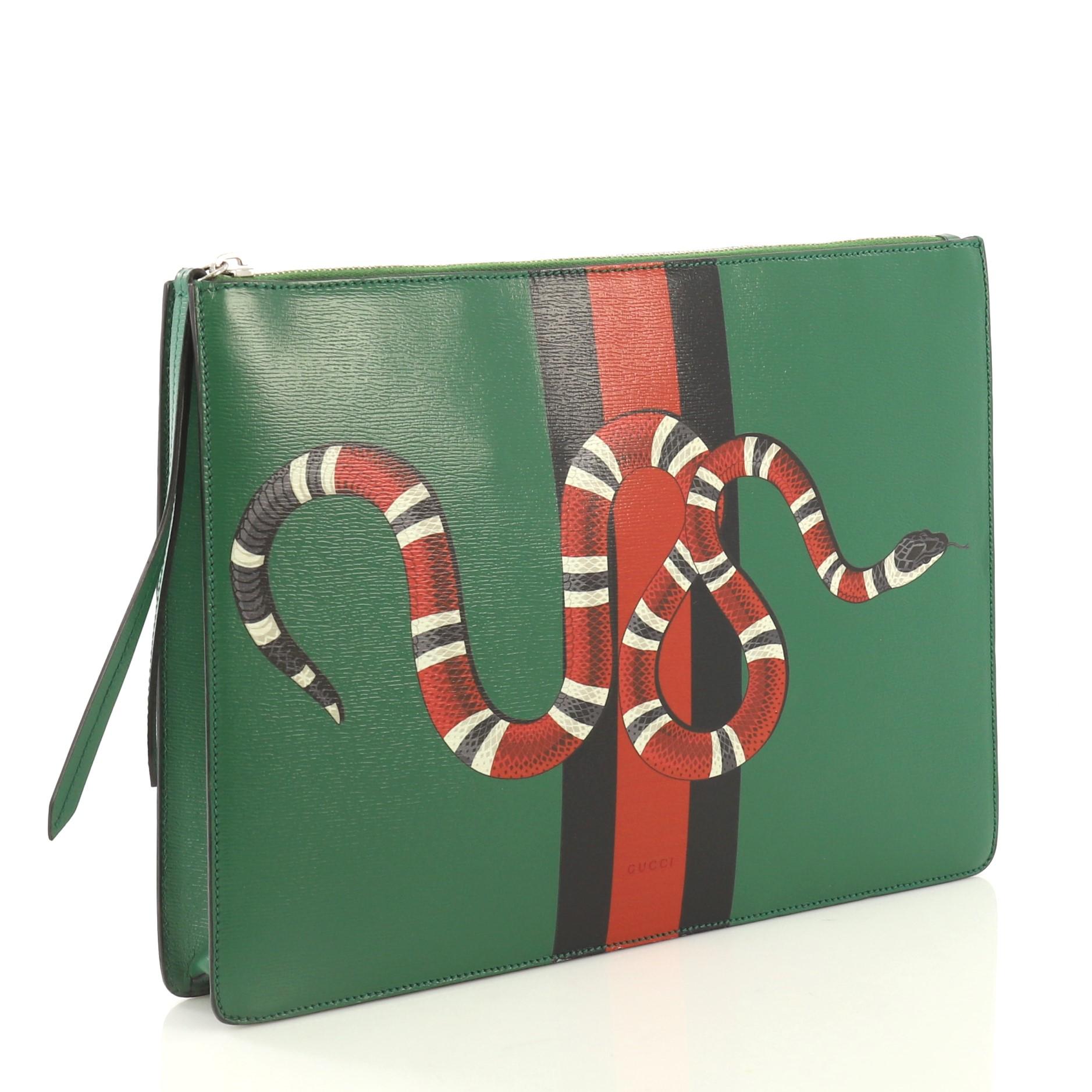 This Gucci Web and Snake Messenger Bag Printed Leather Large, crafted from green printed leather, features adjustable leather strap, snake print against web detail, and silver-tone hardware. Its zip closure opens to a gray microfiber interior with