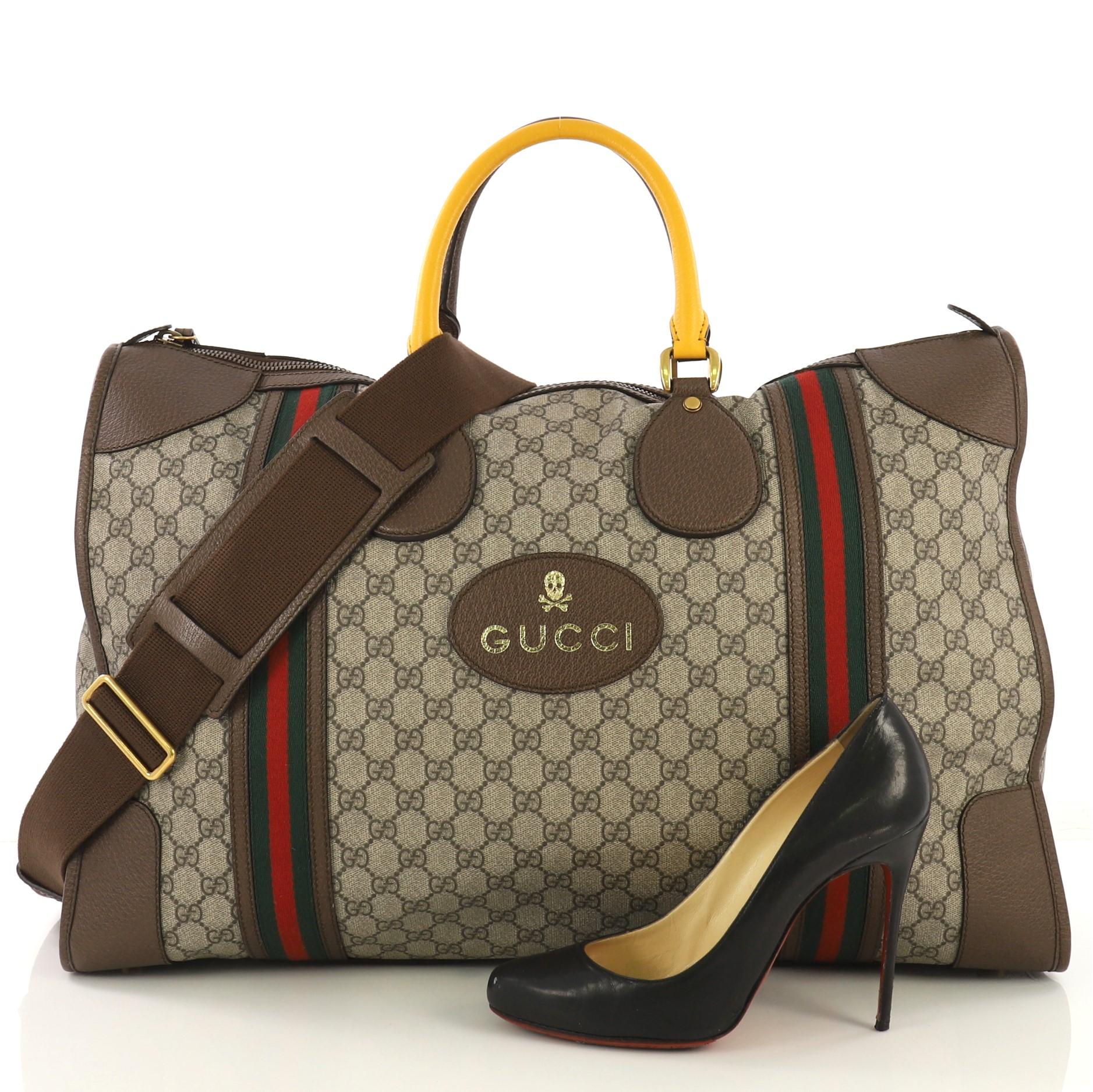 This Gucci Web Convertible Duffle Bag GG Coated Canvas Large, crafted from beige GG coated canvas, features dual rolled handles, web detailing and aged gold-tone hardware. Its zip closure opens to a beige fabric interior with zip and slip pockets.