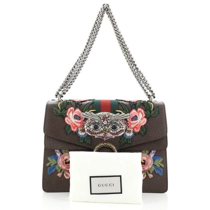 This Gucci Web Dionysus Bag Embellished Leather Medium, crafted from brown embellished leather, features chain link strap, textured tiger head spur detail on its flap and aged silver-tone hardware. Its hidden push-pin closure opens to a neutral