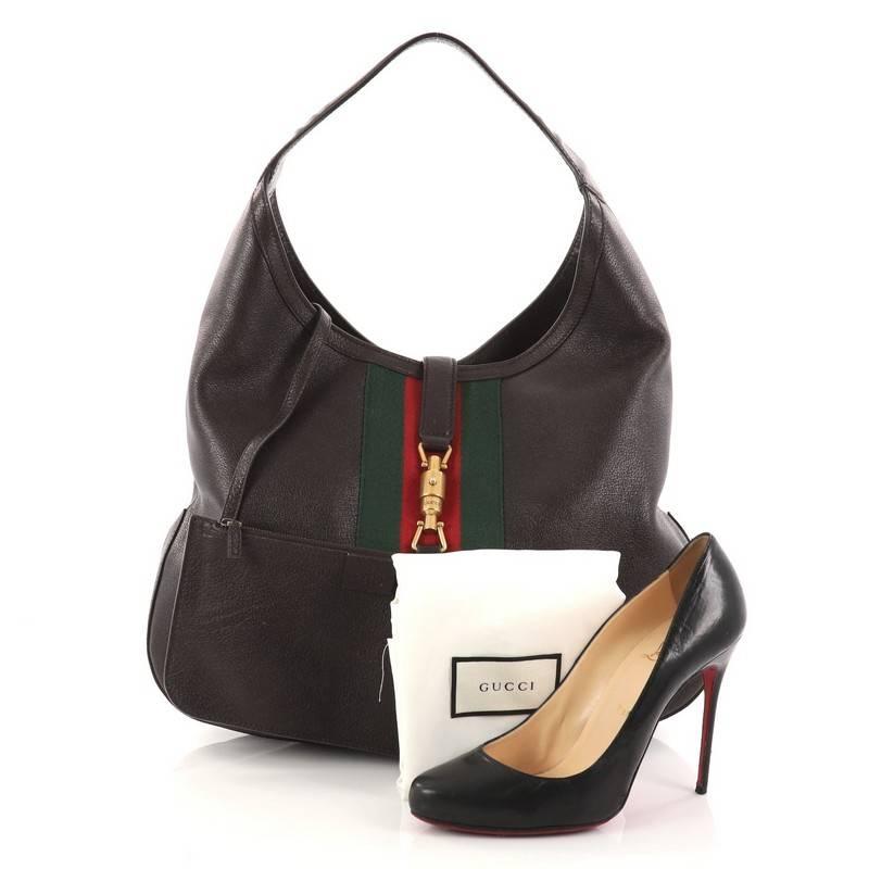 This authentic Gucci Web Jackie Soft Hobo Leather Large is a must-have shoulder bag fit for the modern woman. Constructed from dark brown leather, this bag features looping shoulder strap, signature middle green and red web stripes and gold-tone