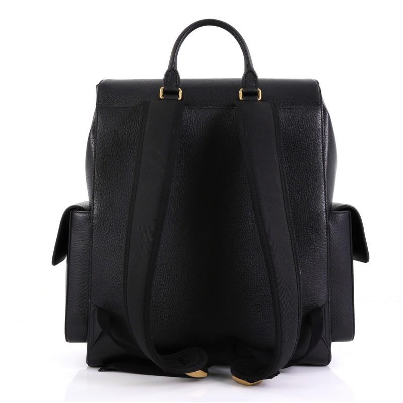 This Gucci Web Pockets Backpack Leather Large, crafted from black leather, features rolled top handle, adjustable shoulder straps, flap pockets on both sides, and aged gold-tone hardware. Its top flap opens to a red fabric interior. 

Estimated